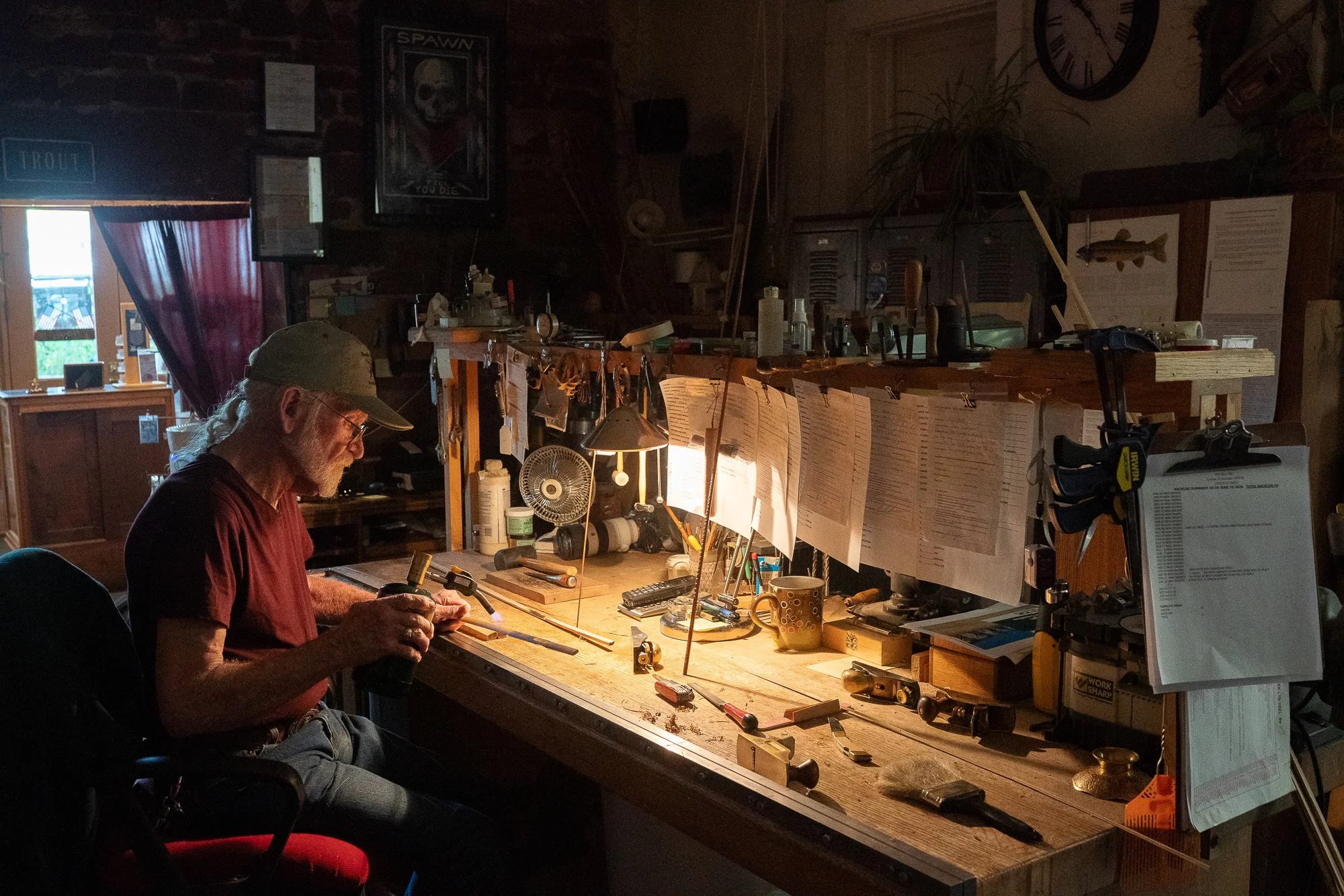 Mike Clark working at his bamboo fly rod workbench surrounded by tools at South Creek Ltd.