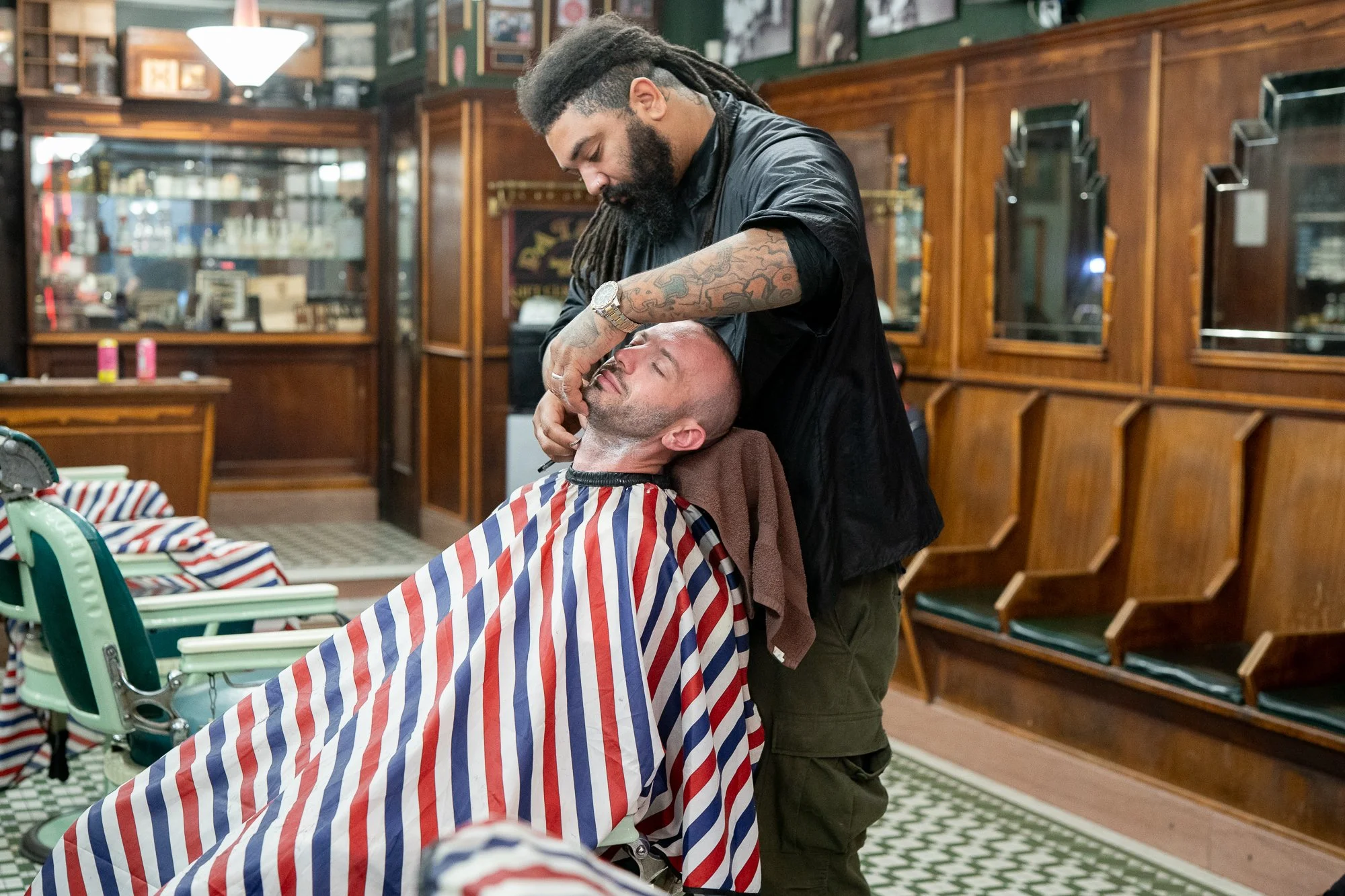 Barber giving a straight razor shave at Patsy’s Barbershop in Albany New York