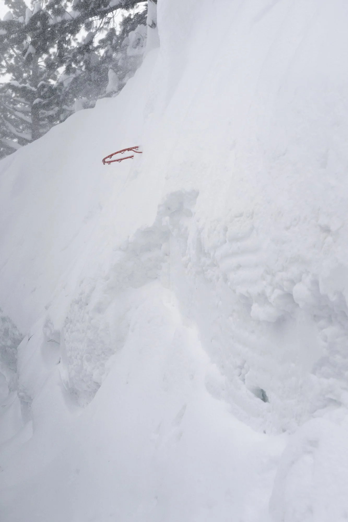 A basketball hoop completely covered in snow after a record breaking winter storm in Mammoth Lakes, California