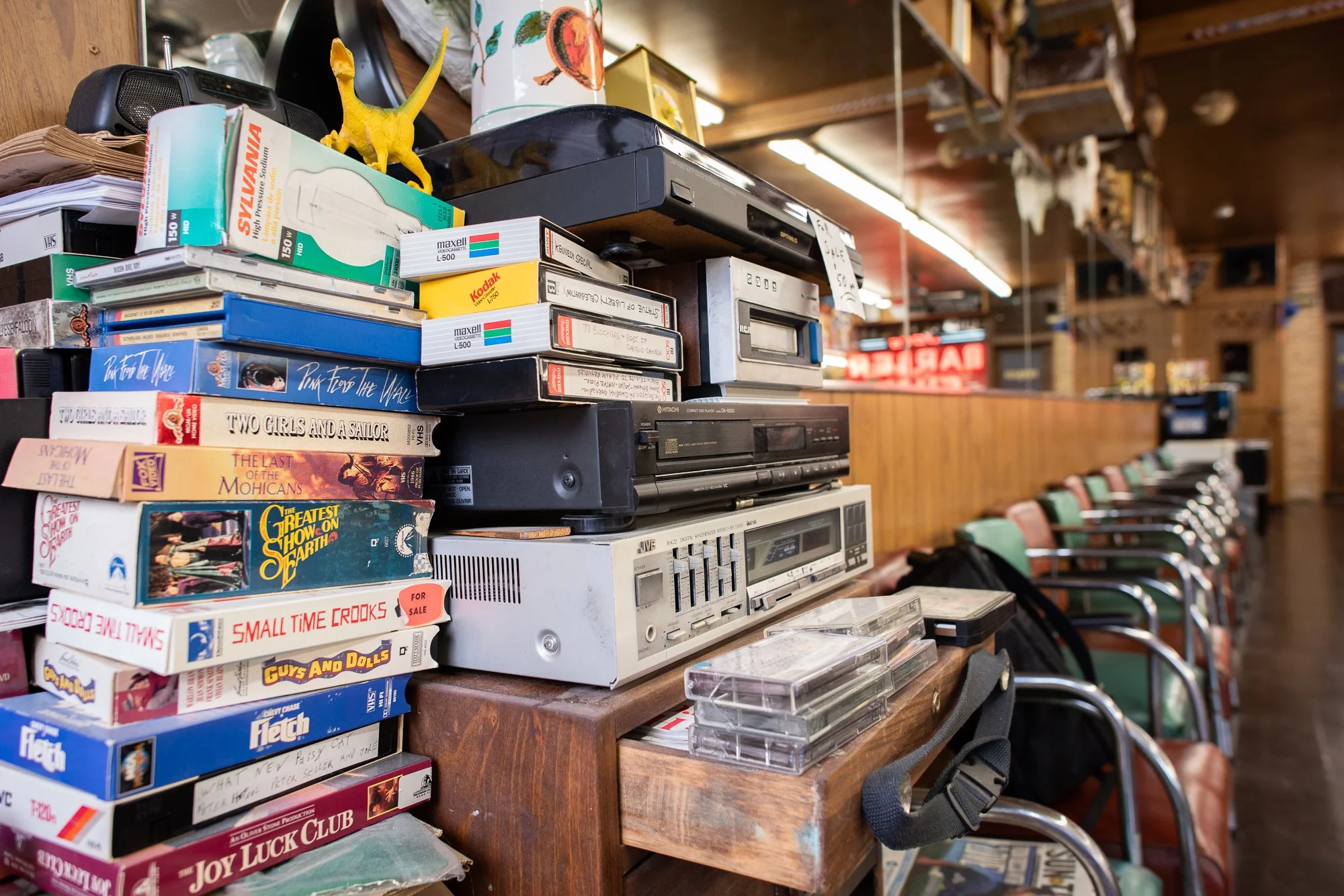 Stack of VHS tapes and old electronics inside Joe’s Barbershop in Chicago