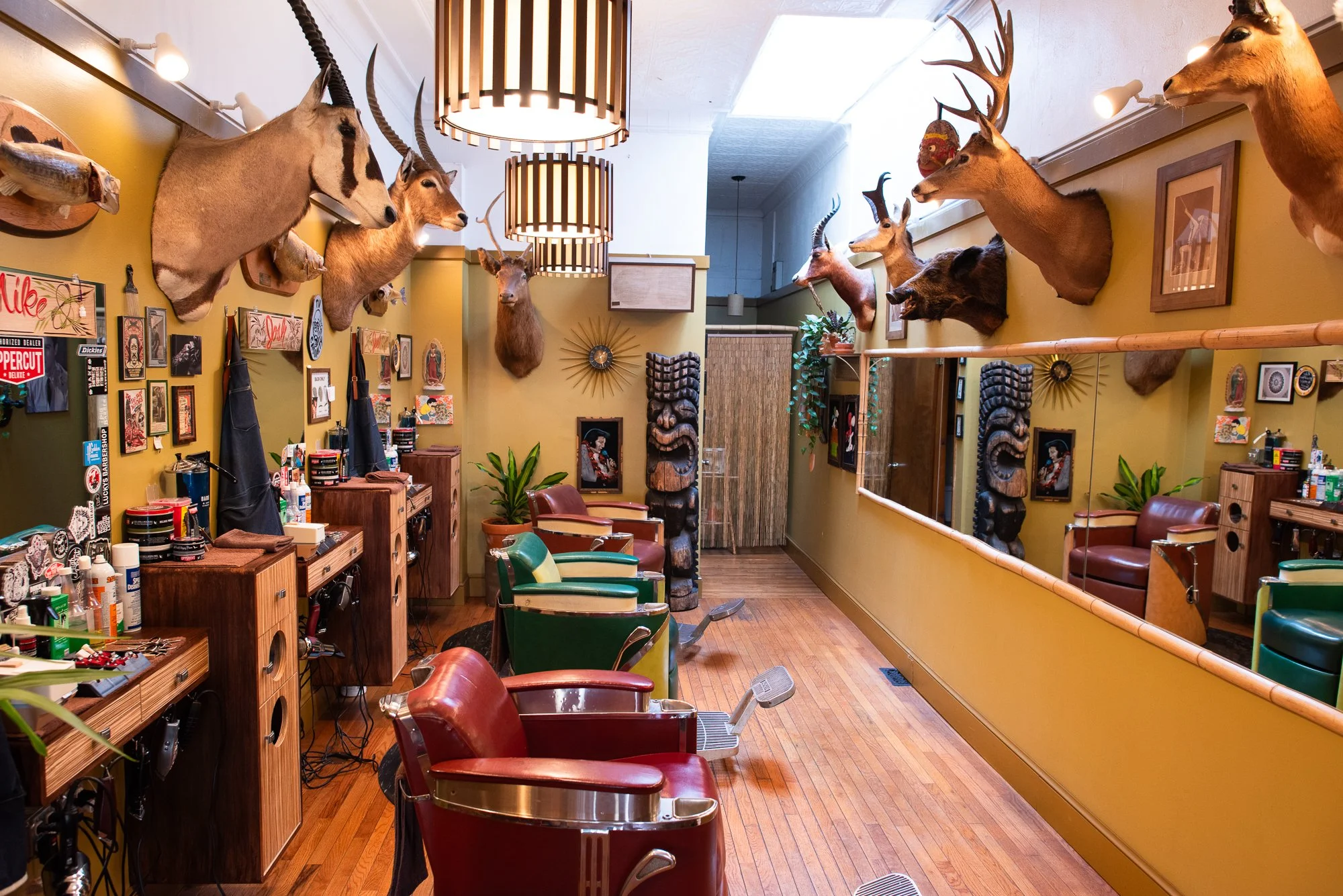Barber stations and vintage decor line the interior of Pugsly’s barbershop in Kingston, New York.
