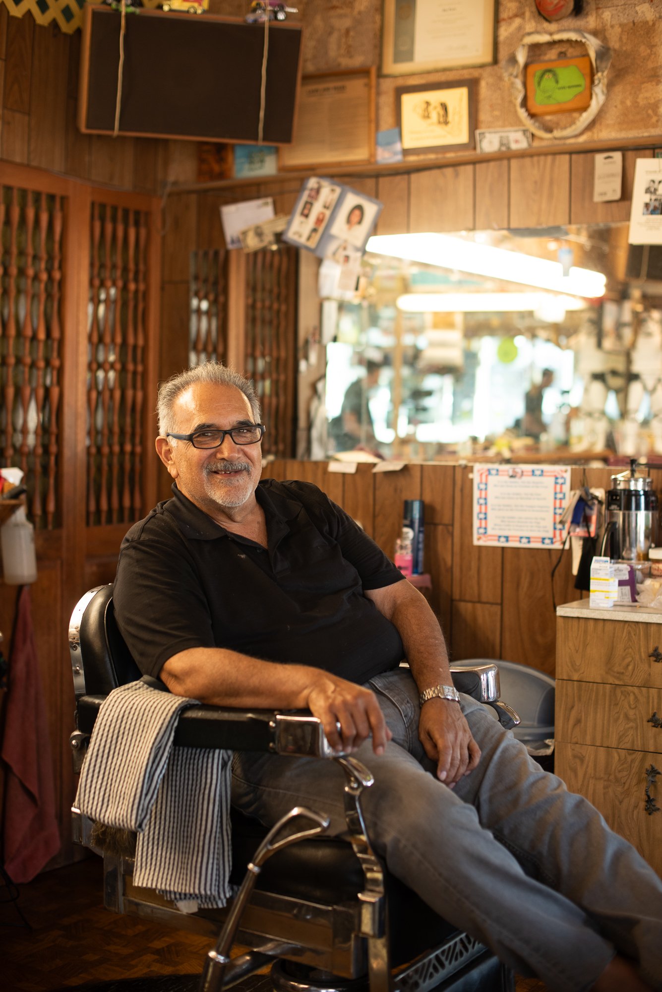 Barber sitting in his chair at a traditional barbershop in San Diego, California