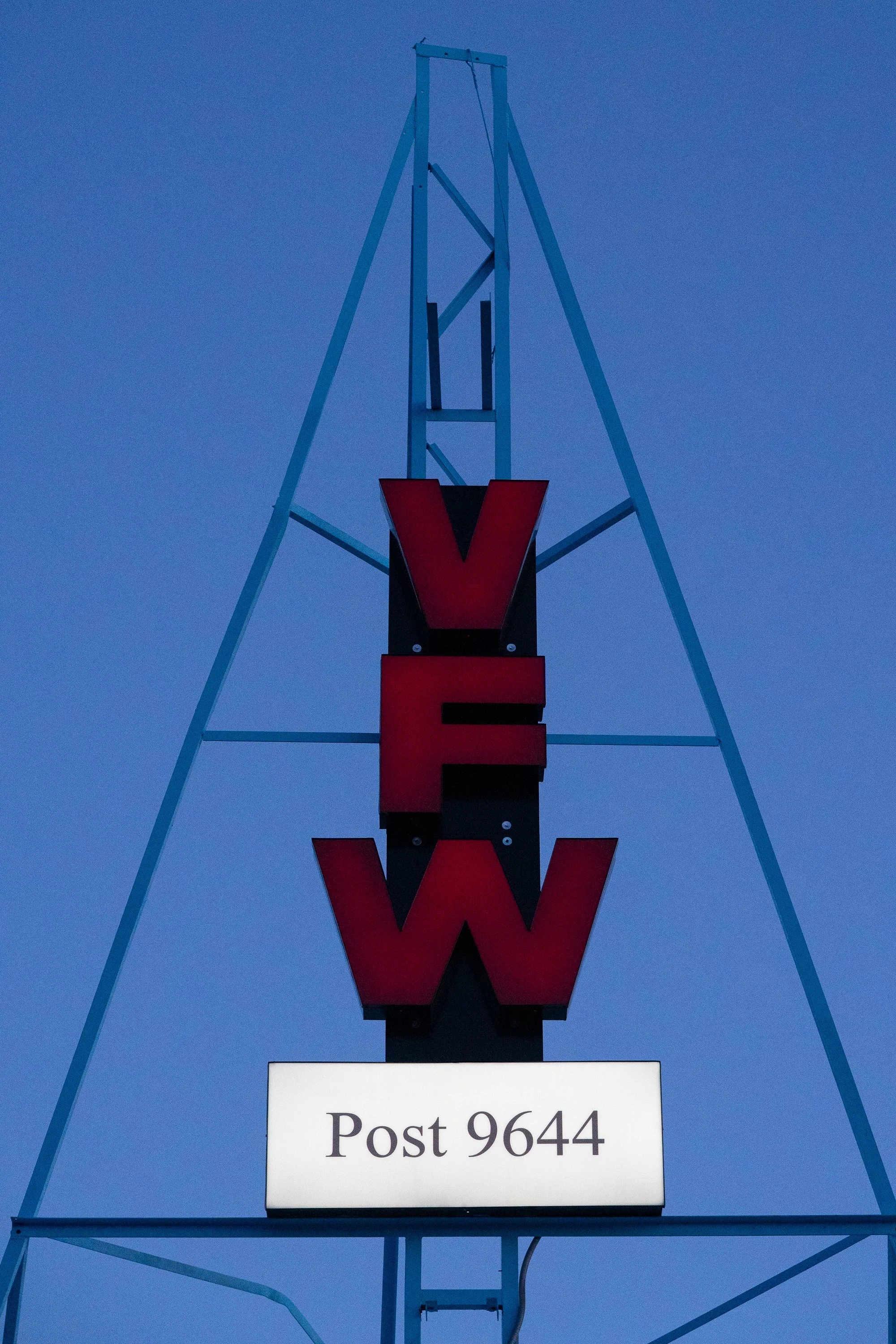 VFW Post 9644 sign photographed against a blue evening sky