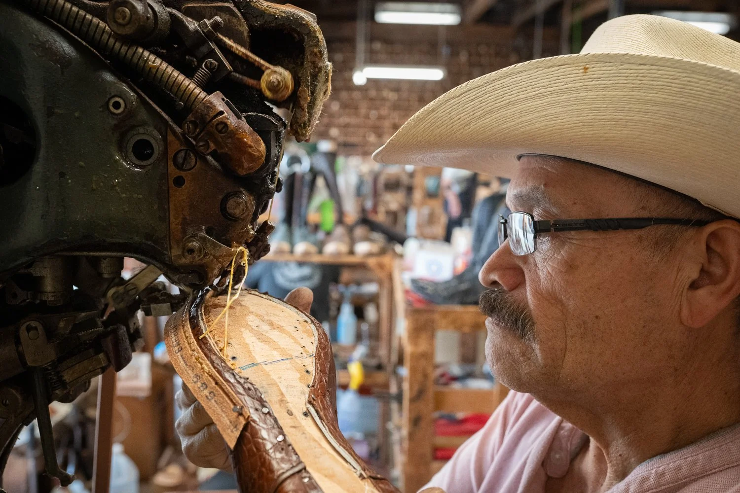 Bootmaker hand-lasting a cowboy boot inside ML Leddy’s workshop in San Angelo Texas