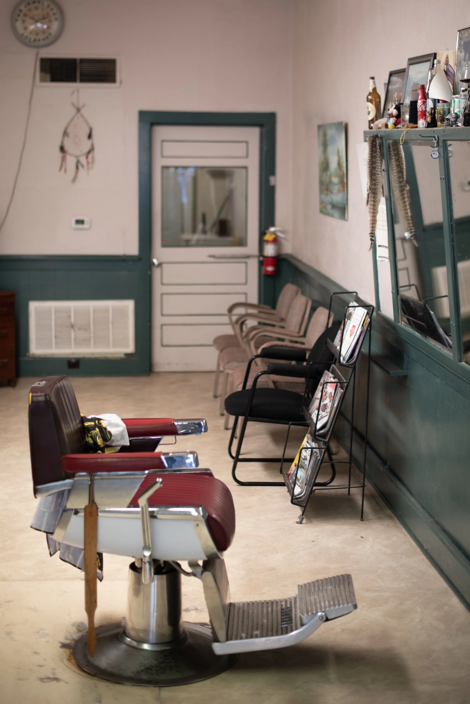 Empty barber chair and waiting area inside Raymond’s Barber Shop in Lockhart, Texas.