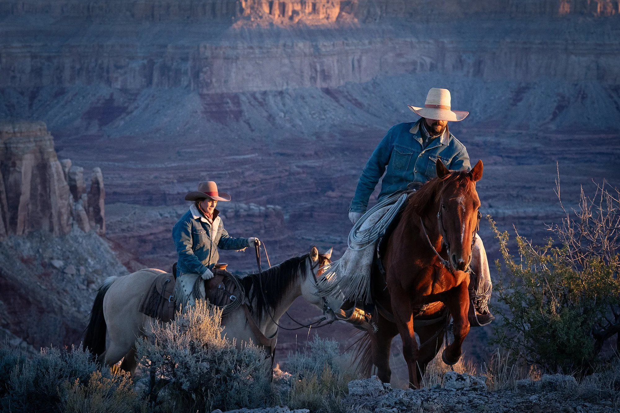 A cowboy riding on horseback through a canyon landscape, suited for western wall art and large wall decor for living rooms
