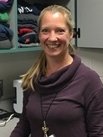 Julie Rolling, Mahtomedi Middle School Counselor, in front of the extra clothing she keeps on hand in her office for students in need.