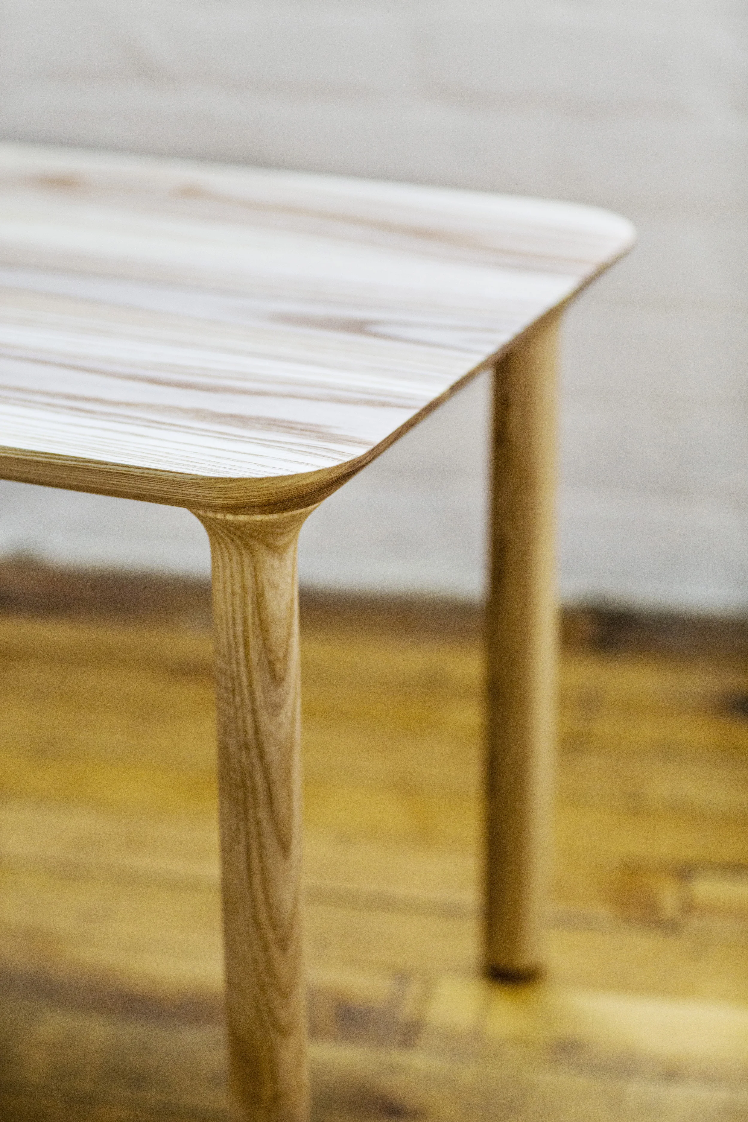 The leg detail flows seamlessly into the top surface for a unified appearance.