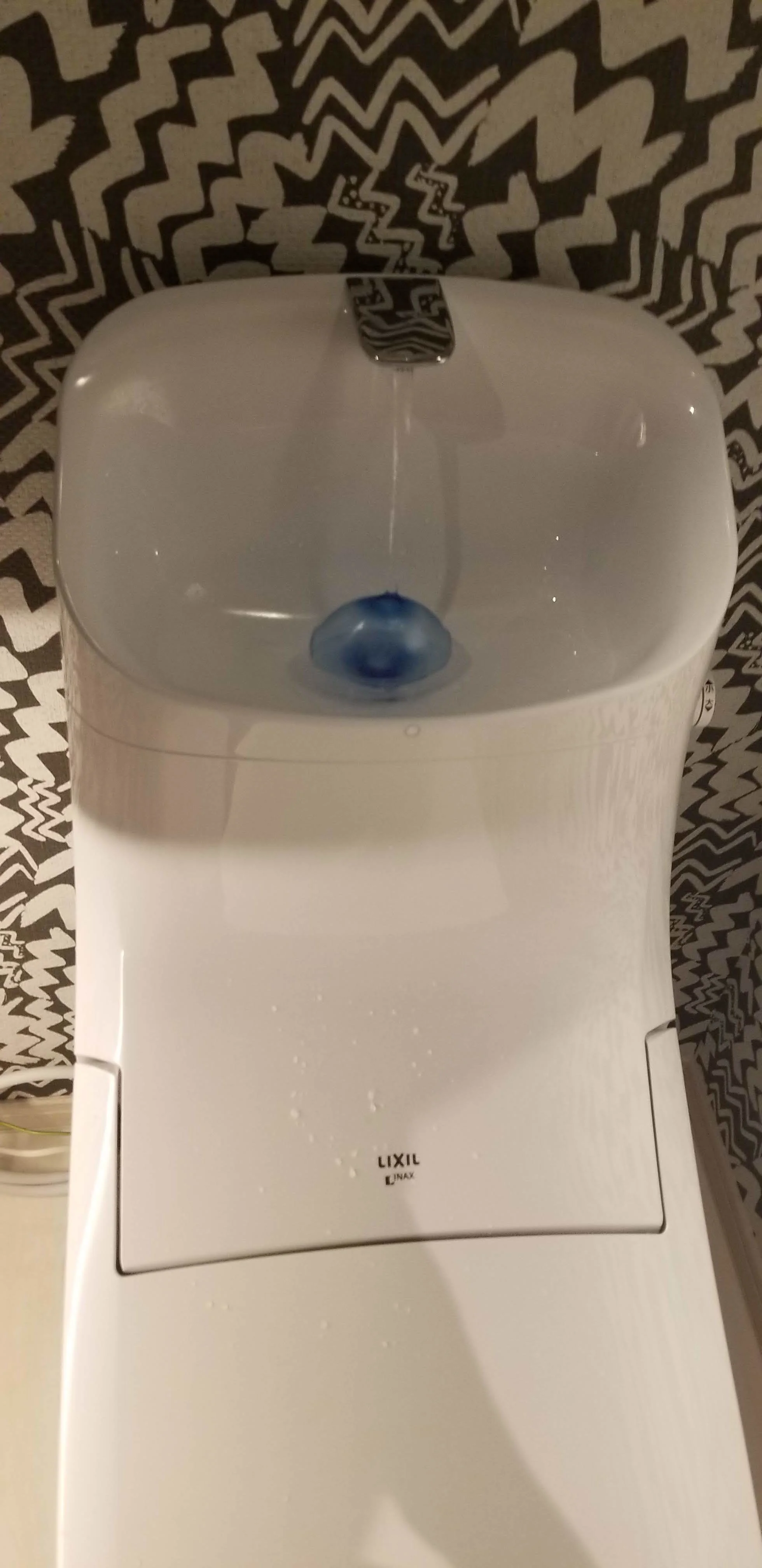 Immediately after the flush- water running into the hand-washing area.