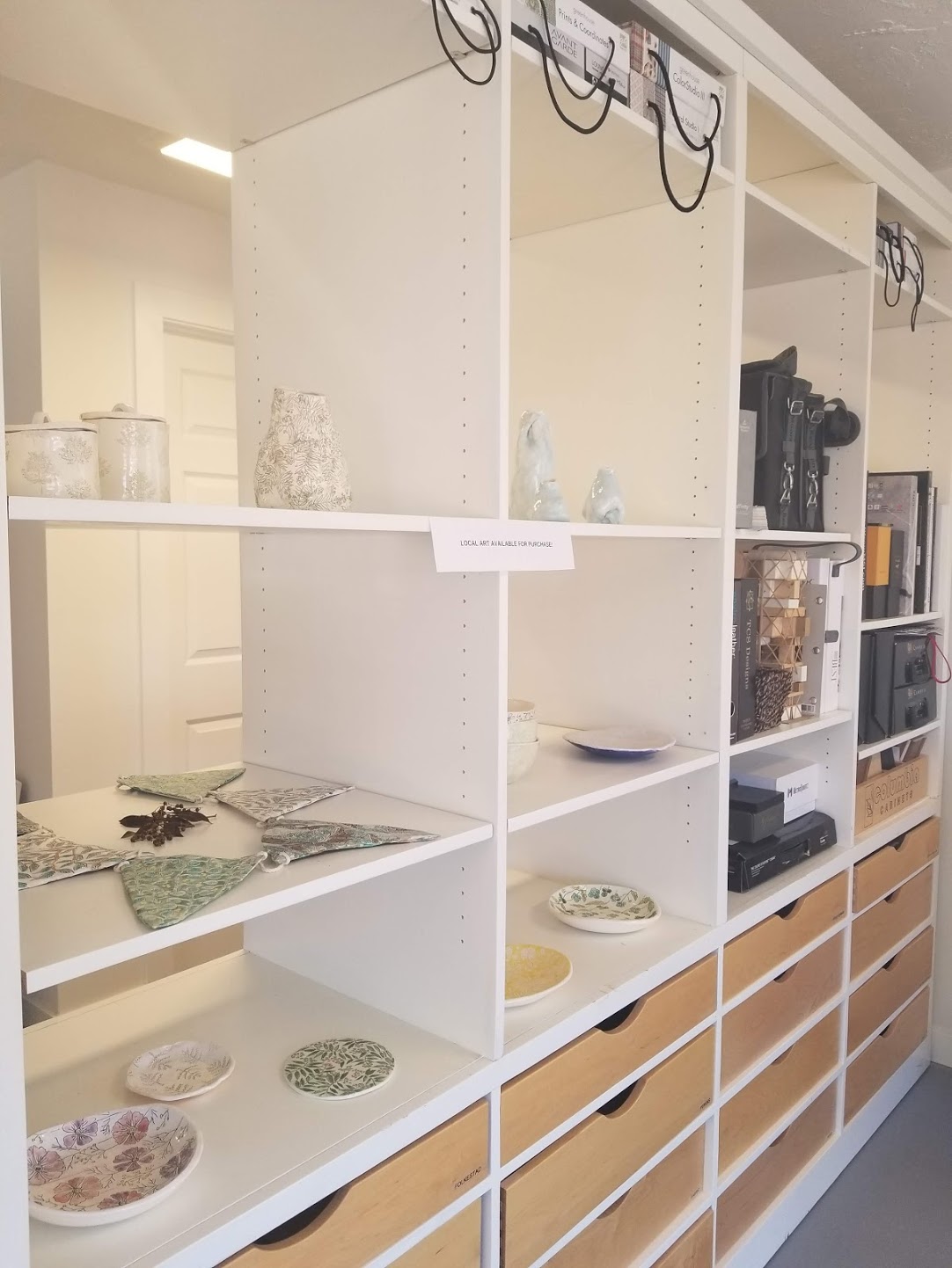 We set aside space on our display shelves for local potters such as Dorotea Ceramics (shown here) to display and sell their work.