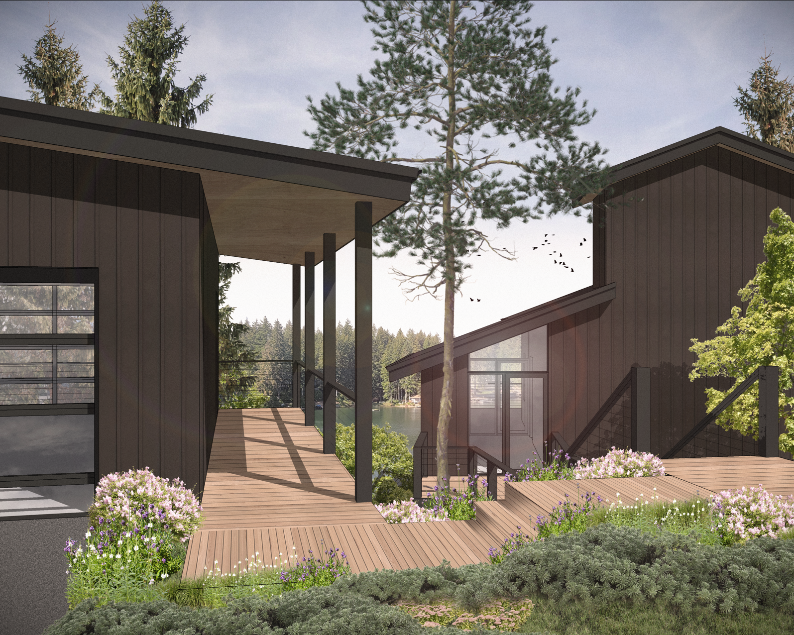 Modern black wooden houses with large windows, connected by wooden walkways, surrounded by flowering bushes and trees, with a lake and forest in the background under a partly cloudy sky.