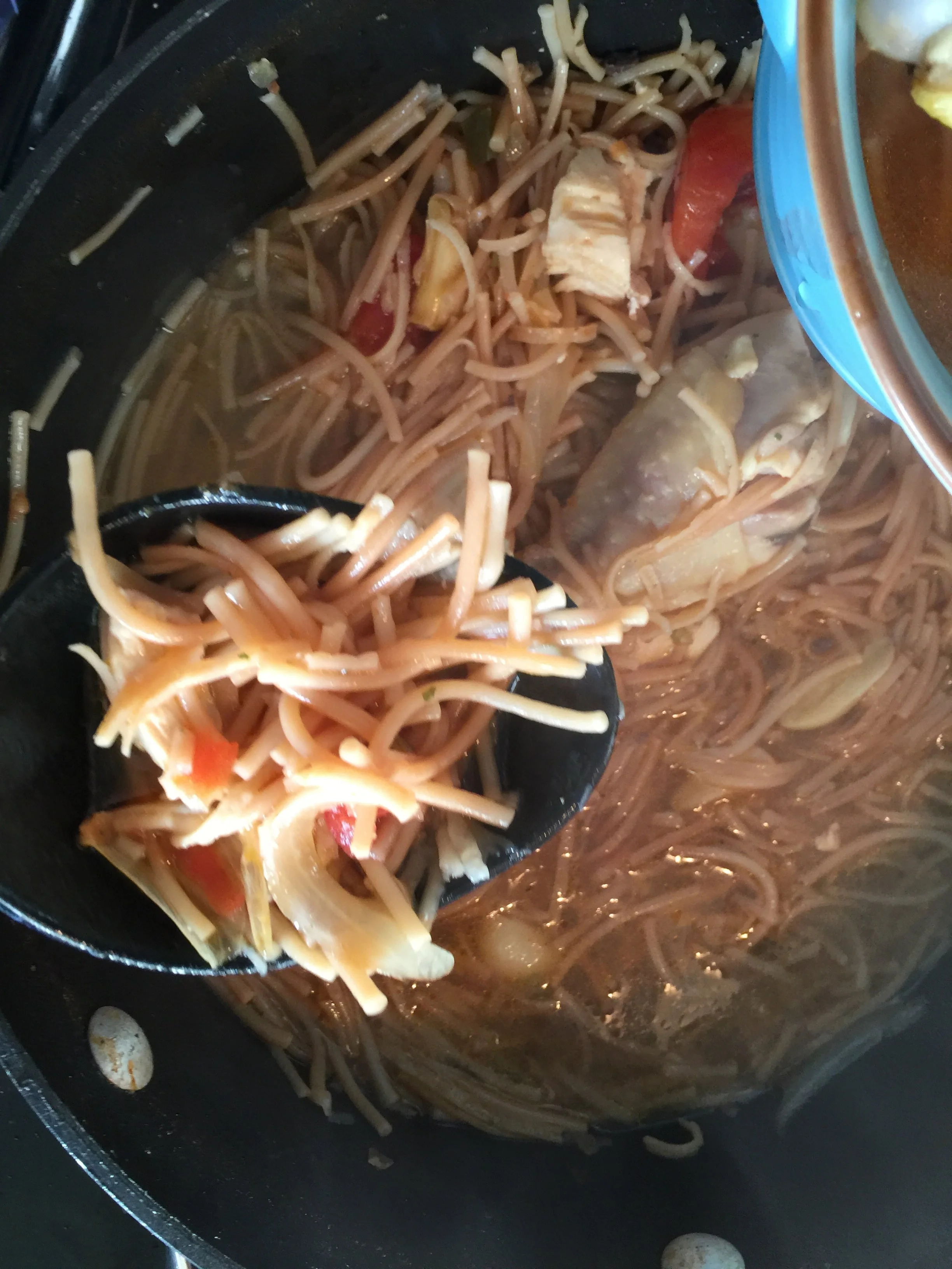 Finally add your chicken and broth to the fideo. Keep in mind I enjoy mine very soupy so I'll add broth as I go (Be sure to cover your pan so the fideo can finish cooking after you add your chicken) Let it simmer for about 15mins. 
