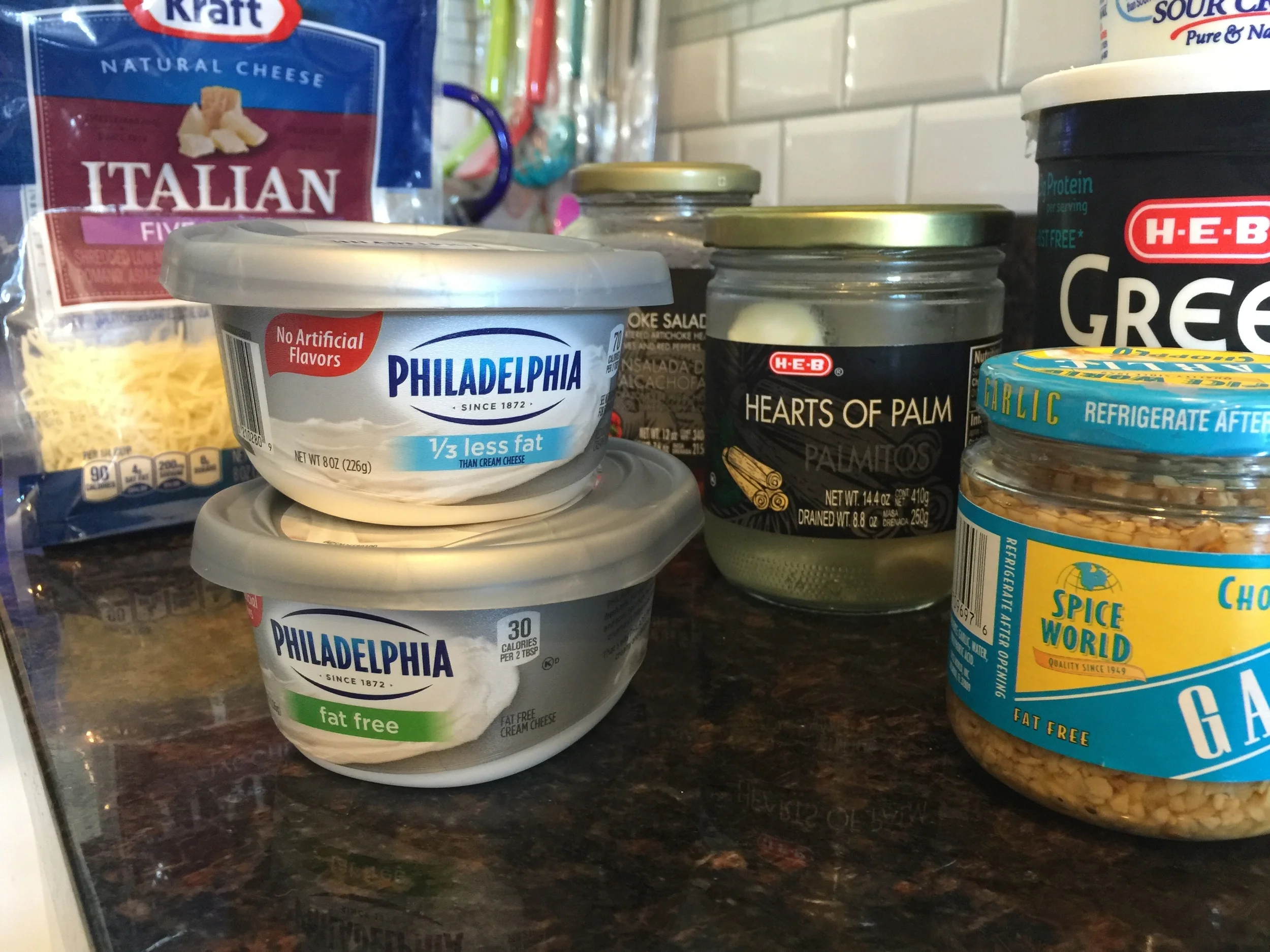 Cream Cheese 1/2 cup of Greek Yogurt 1/4 cup of Sour Cream 2 tsp of Garlic 2 handfuls of fresh spinach Italian or Parmesan Cheese 1 small can of artichoke hearts 1 small can of Hearts of Palm