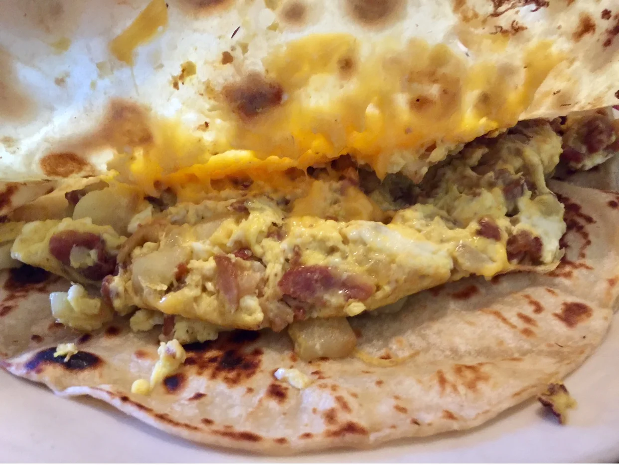 Breakfast Tacos: all of them are delicious & big enough to share. This one I ordered has egg, potatoe, bacon, cheese & a side of refried beans. 