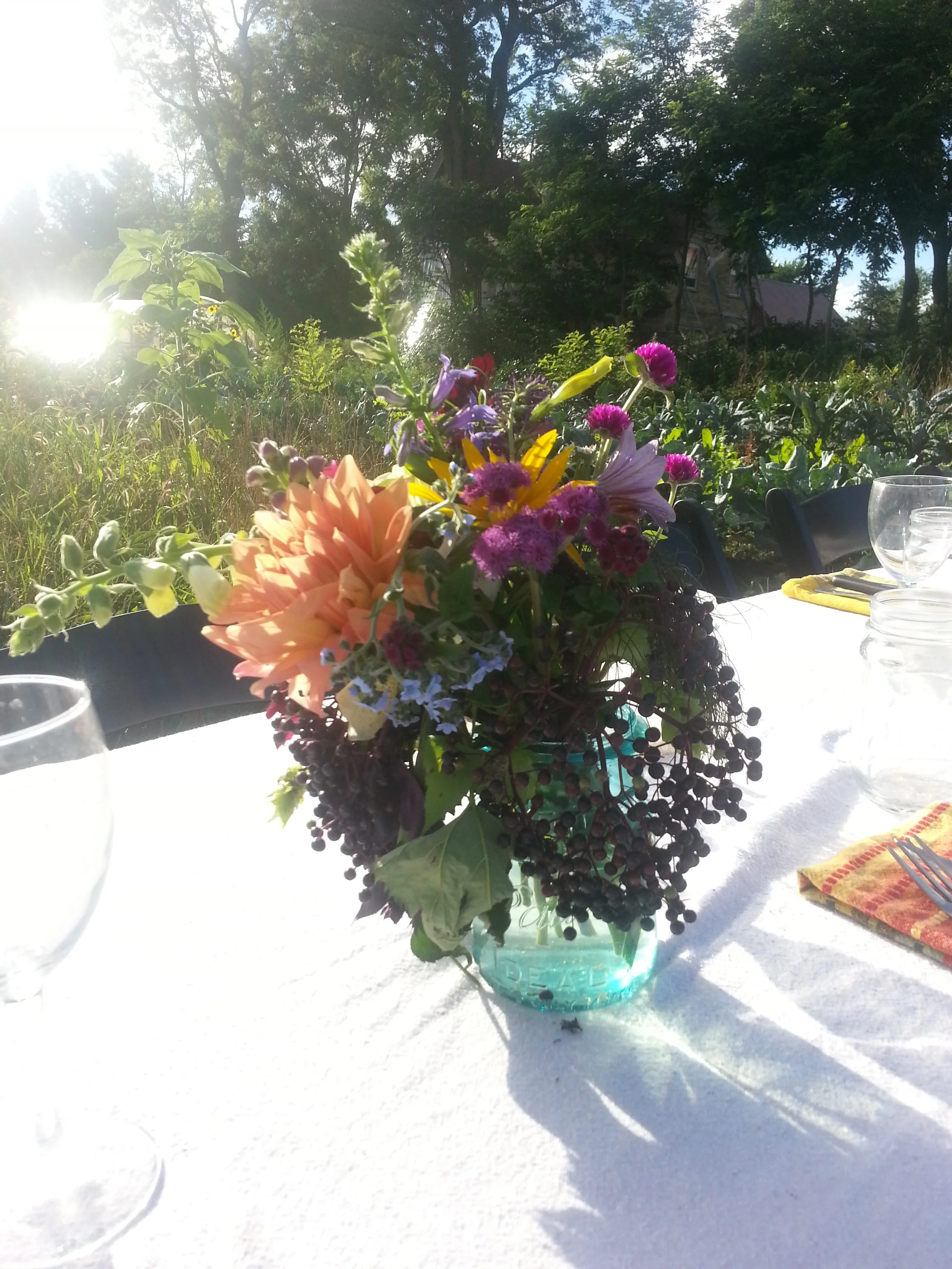 Floral arrangements consists of garden blooms such as: dahlias, forget me nots, elderberries, globe amaranth and other amaranths, zinnias, lisianthus, hops native lobelia, snapdragons, sweet peas , sunflowers, cosmos, and surely many other miscilaneous flowers.