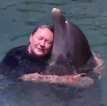 Sara&DolphinHug .png