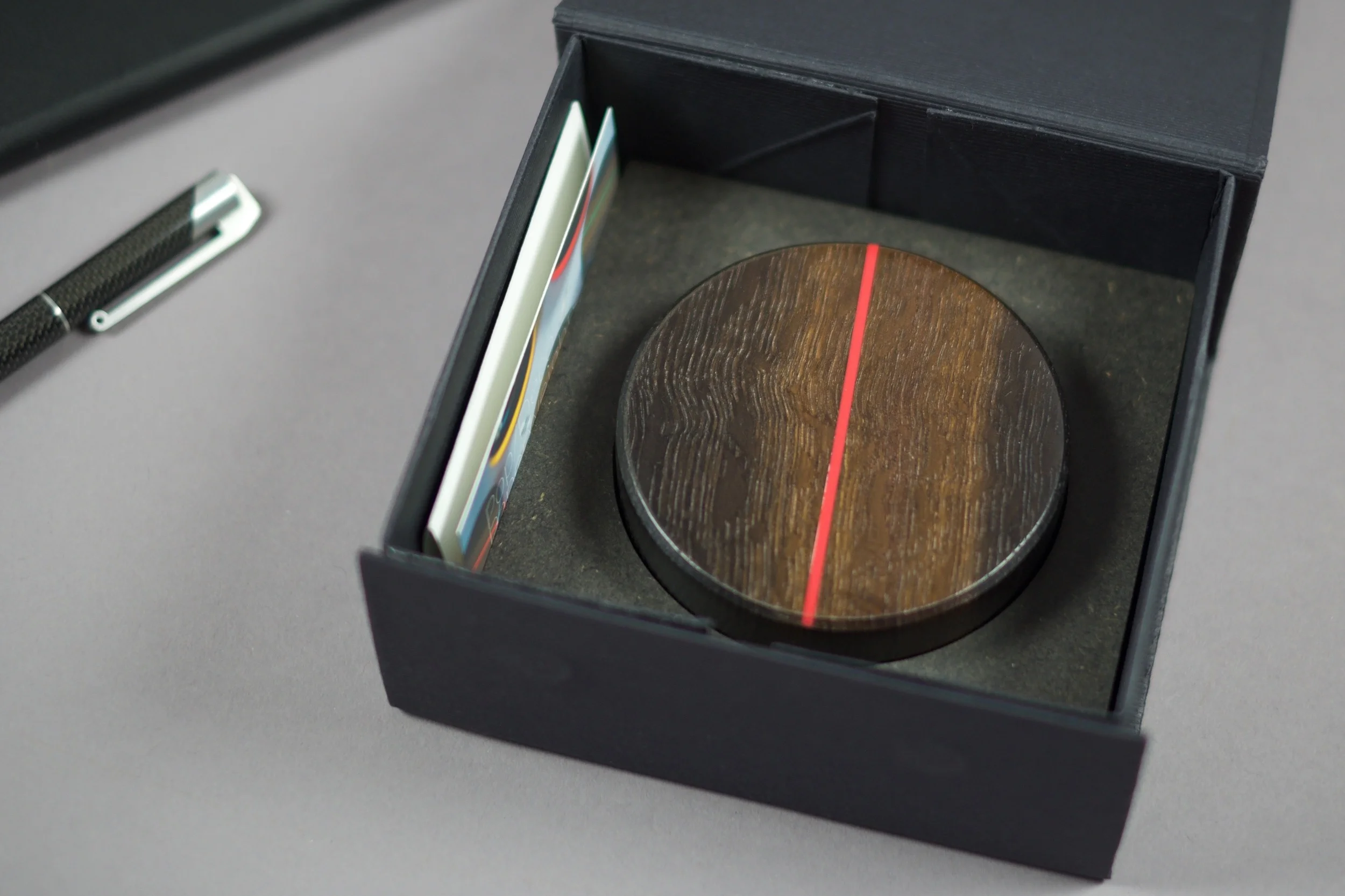 The Paperweight is presented and held in place by a twin layer of colour matching Valchromat. The box also contains a small printed leaflet outlining the materials used. 