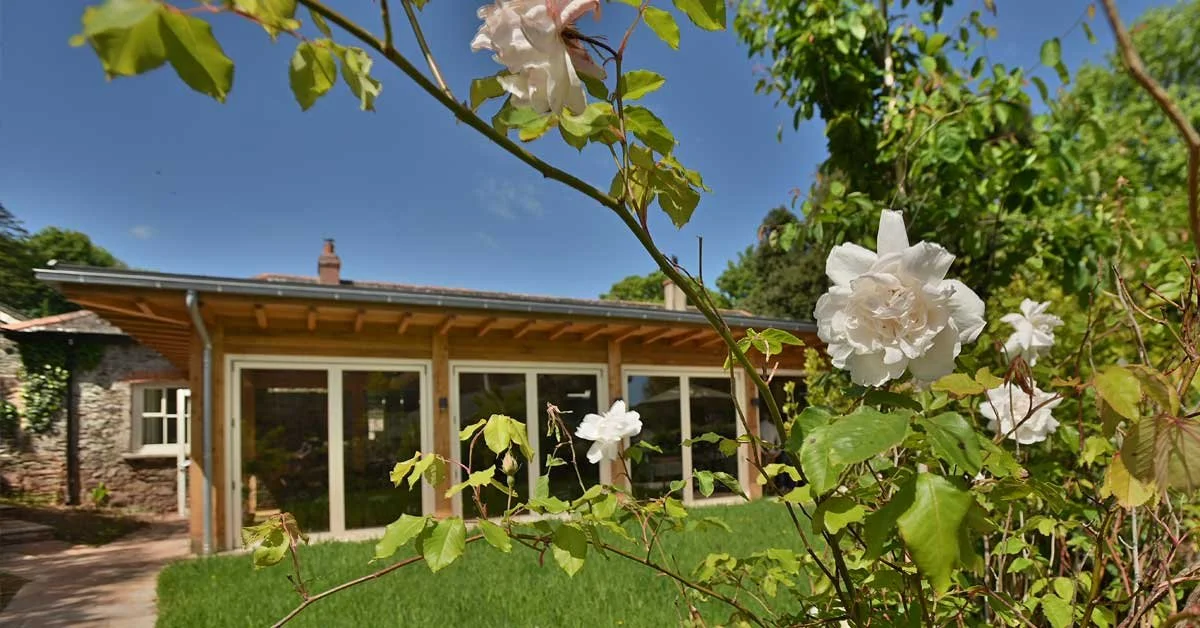 web_pic_1200_px_wide_coach_house_exterior_with_roses-image(1200x628-crop-autorotate).jpg