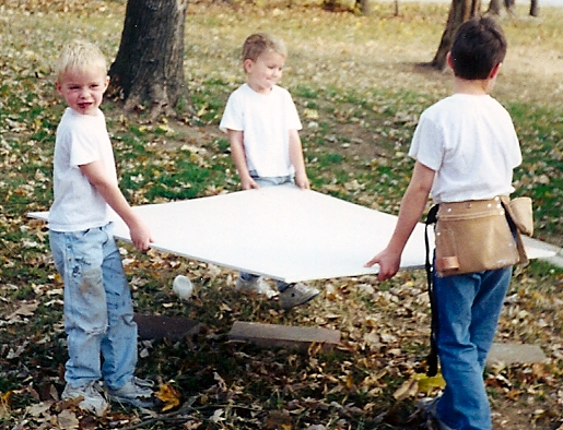1999: Andrew, Peter and Ben carrying drywall for Rich.