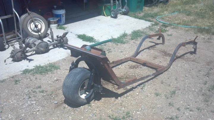 The remains of the 3 wheel golf cart after being stripped and extending the frame.