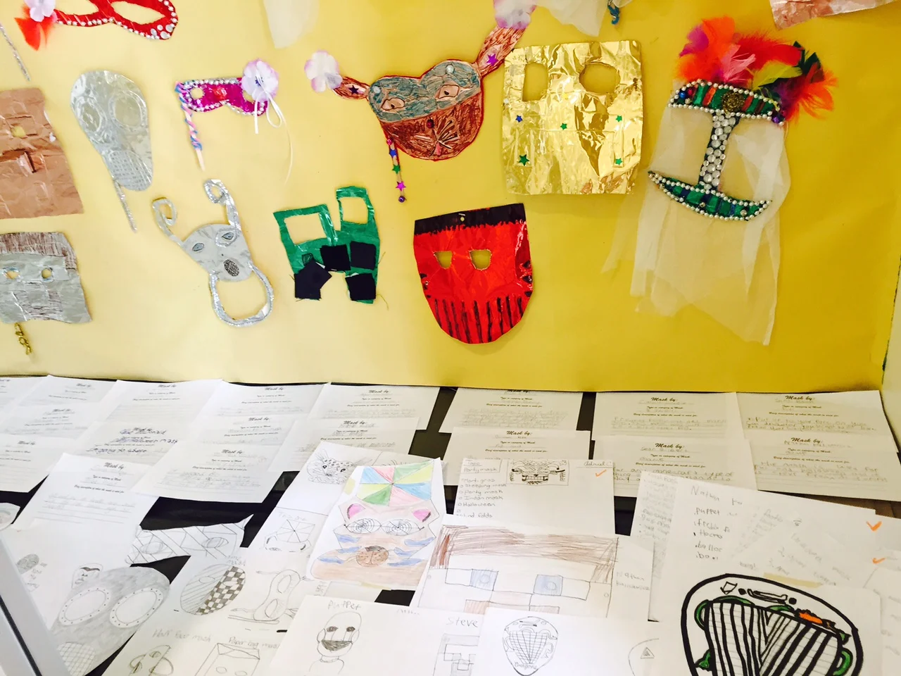 Sixth Grade Mask display showing mask categories and rough drafts 