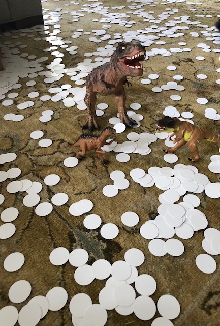 T-Rex and friends on a field of volcanic ash.