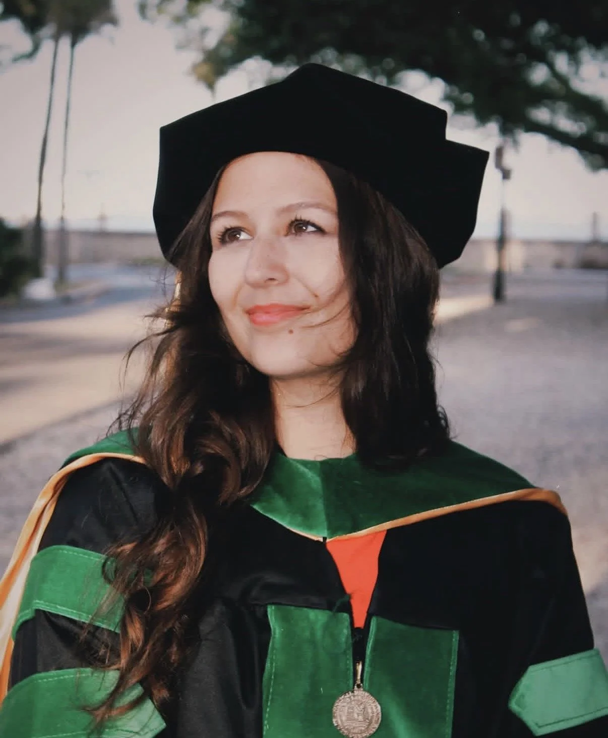 Woman in medical school graduation cap and gown