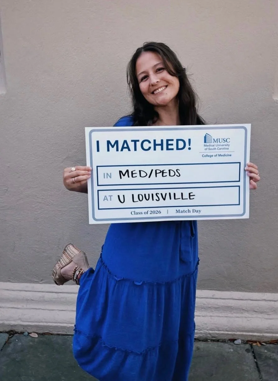 Girl in Blue Dress with I matched sign