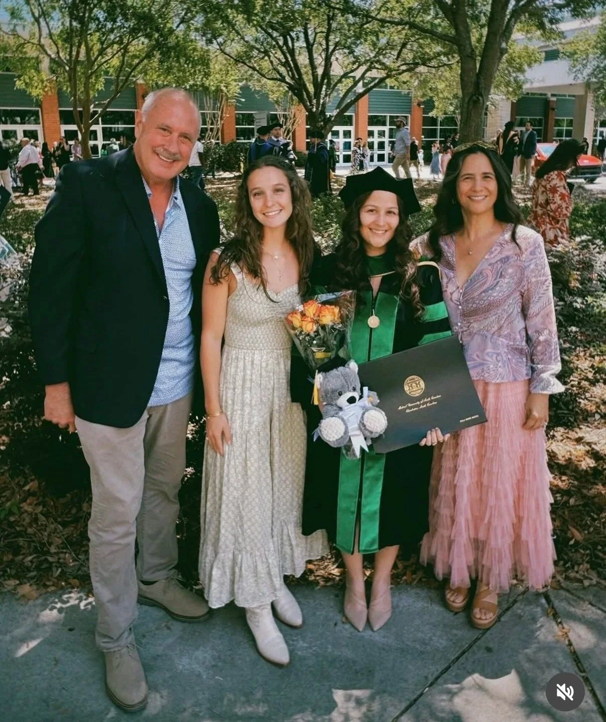 Group of a graduate in MD robes surrounded by family