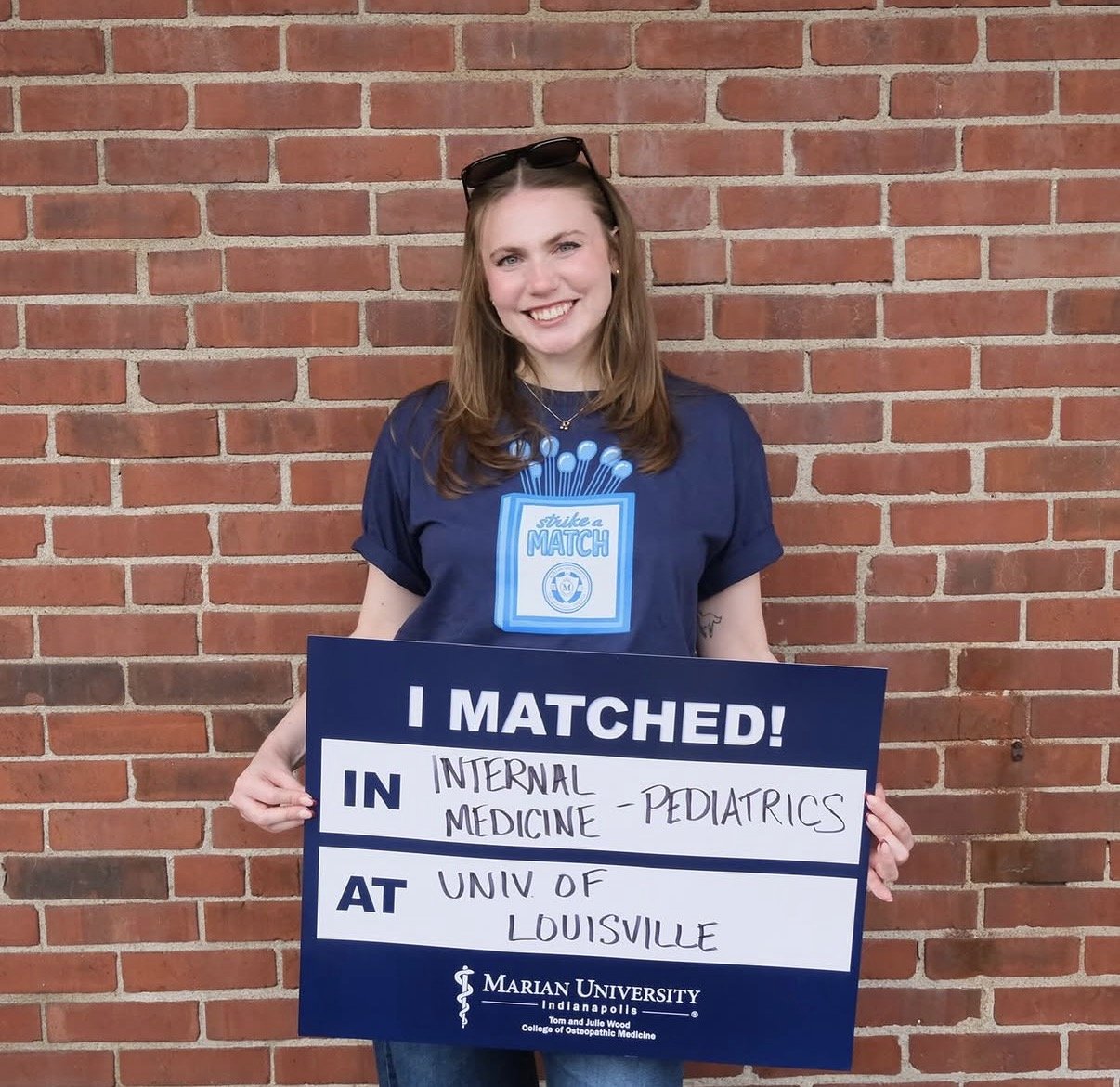 Woman holding I Matched Sign