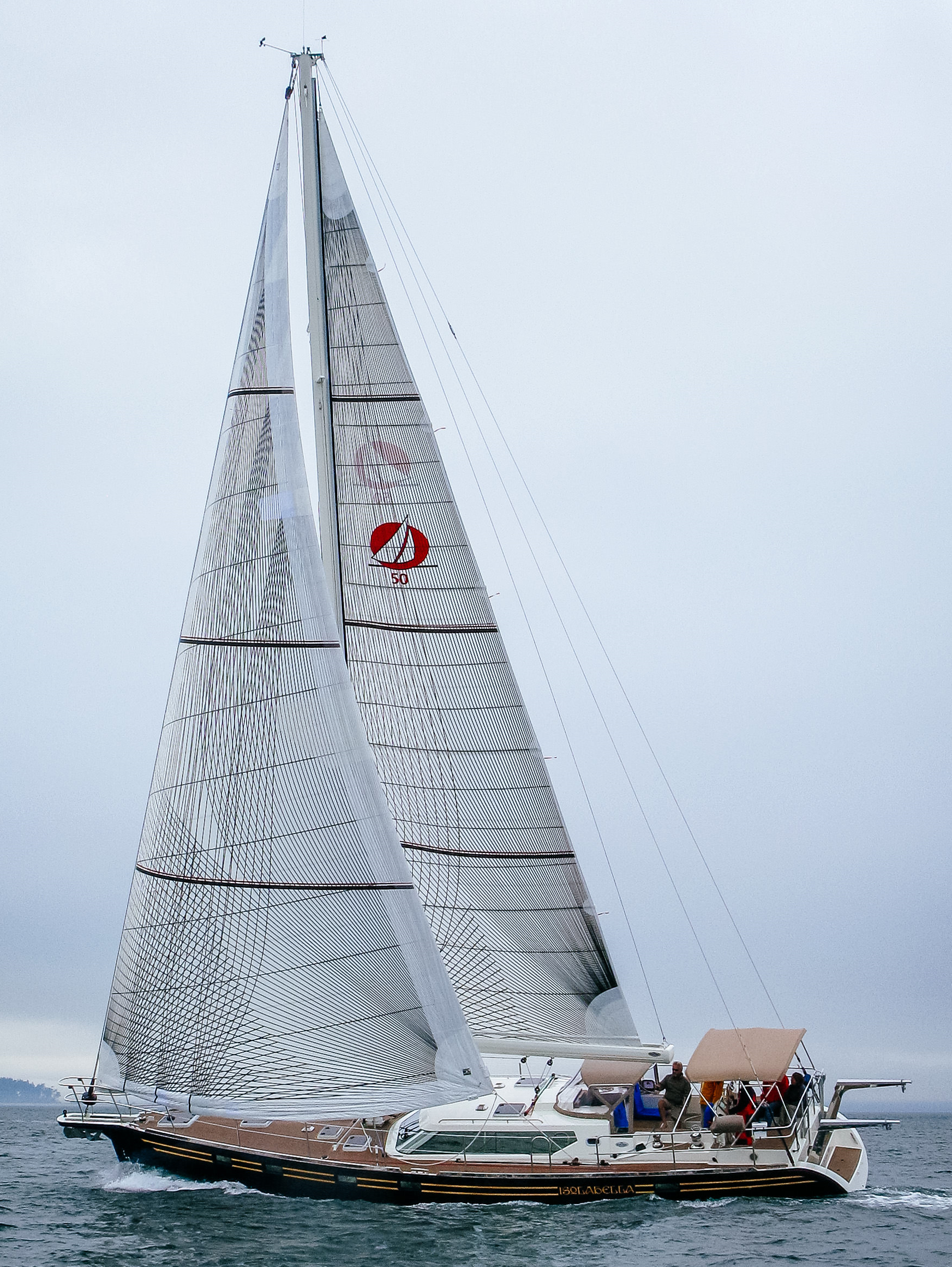 A Waterline Yachts 50 with Tape-Drive carbon Spectra performance cruising roller-reefing genoa and mainsail. Notice the 3 reef points that include sets of tapes to carry the reefed luff loads.