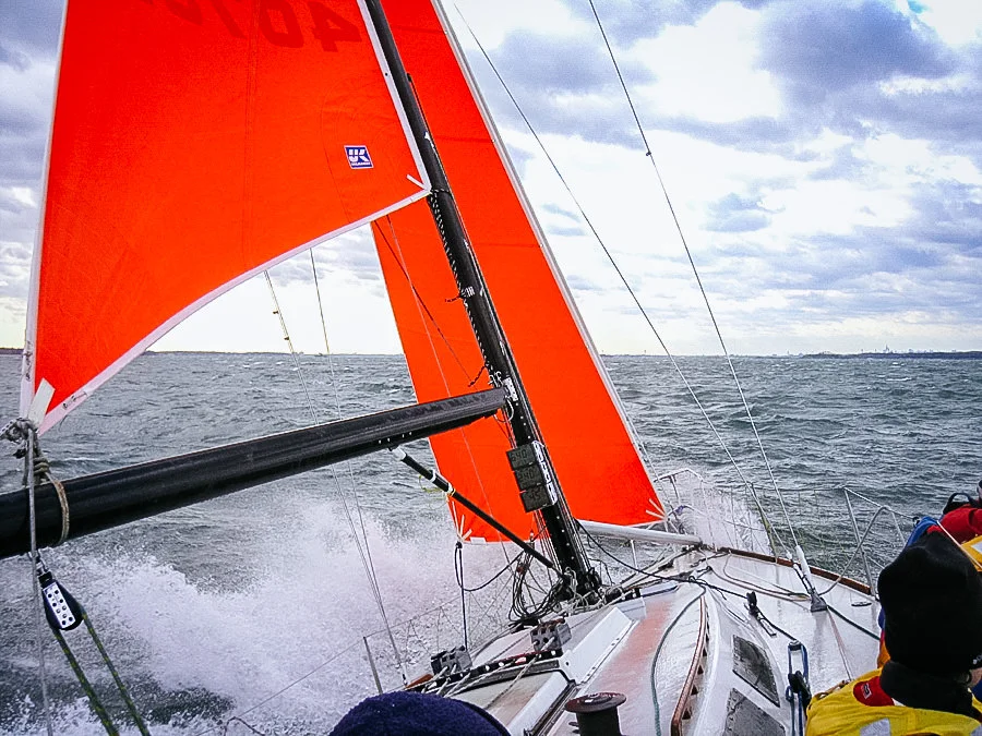 PHOTO 2: Here the trysail is clew is secured to the boom with a reef line and then stropped to the boom with a separate line. With the sail attached to the boom, it can be trimmed with the mainsheet. Sailing TRIPLE LINDY in 30 knots of wind the day before racing started at Key West Race Week, we discovered this method was safer since there are no sheets shaking violently across the cockpit.