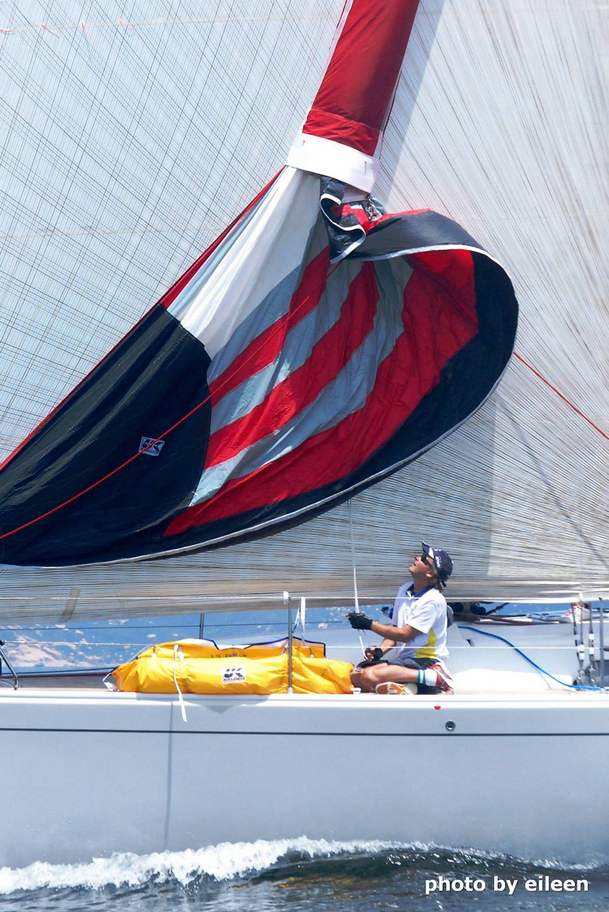 Once the Cruising Spinnaker is raised inside the sock, use the continuous loop halyard to raise the sock to the free the sail. When the cruising spinnaker is flying, the Stasher sits over the top of the sail as shown below.
