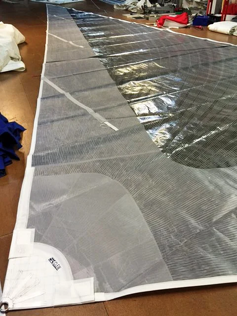 Partial taffeta on the leech of a vertical-batten jib. The taffeta reinforces the area of the sail that may come into contact with the mast and rigging. This part of the leech gets whipped around the most during tacking and luffing.