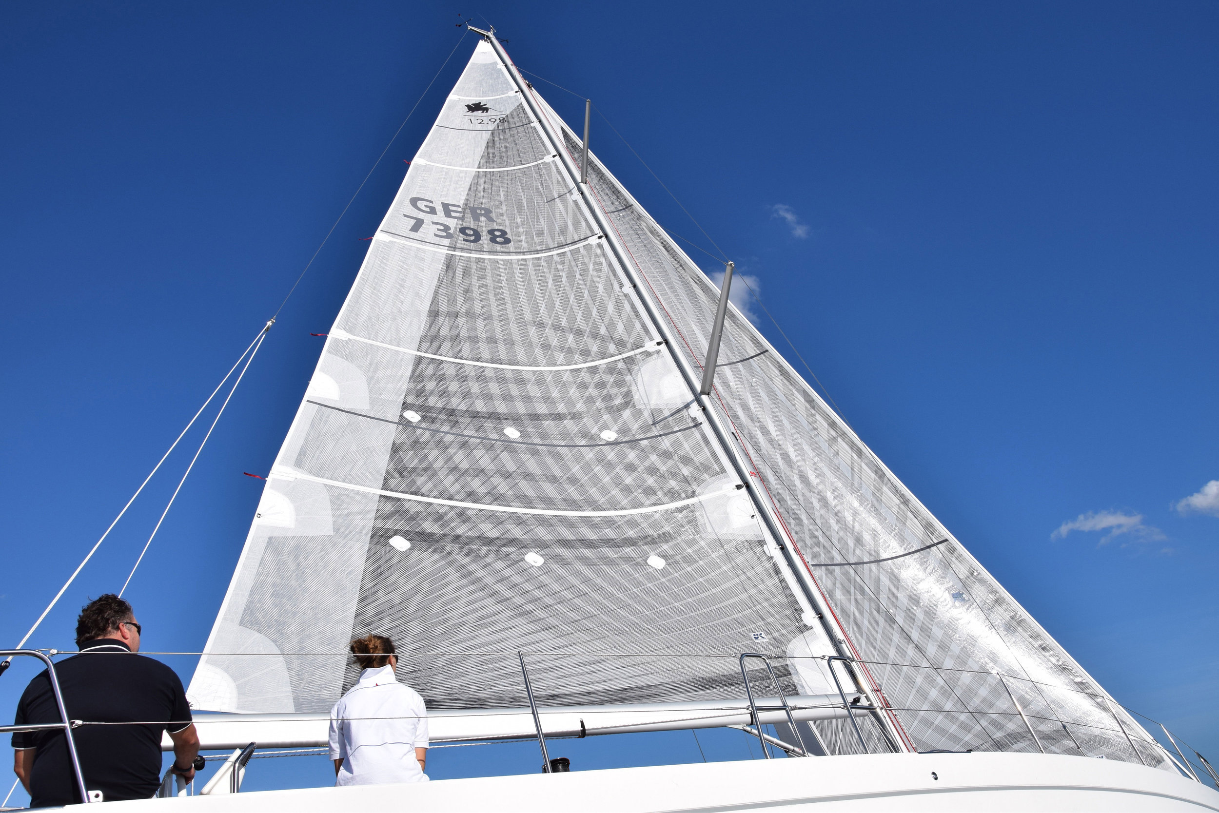 An Italia 12.98 with X-Drive carbon full-batten mainsail and roller/furling genoa. The base laminate has a white taffeta on the side opposite the fibers, while the main has taffeta applied over the fibers on the leech for extra durability.