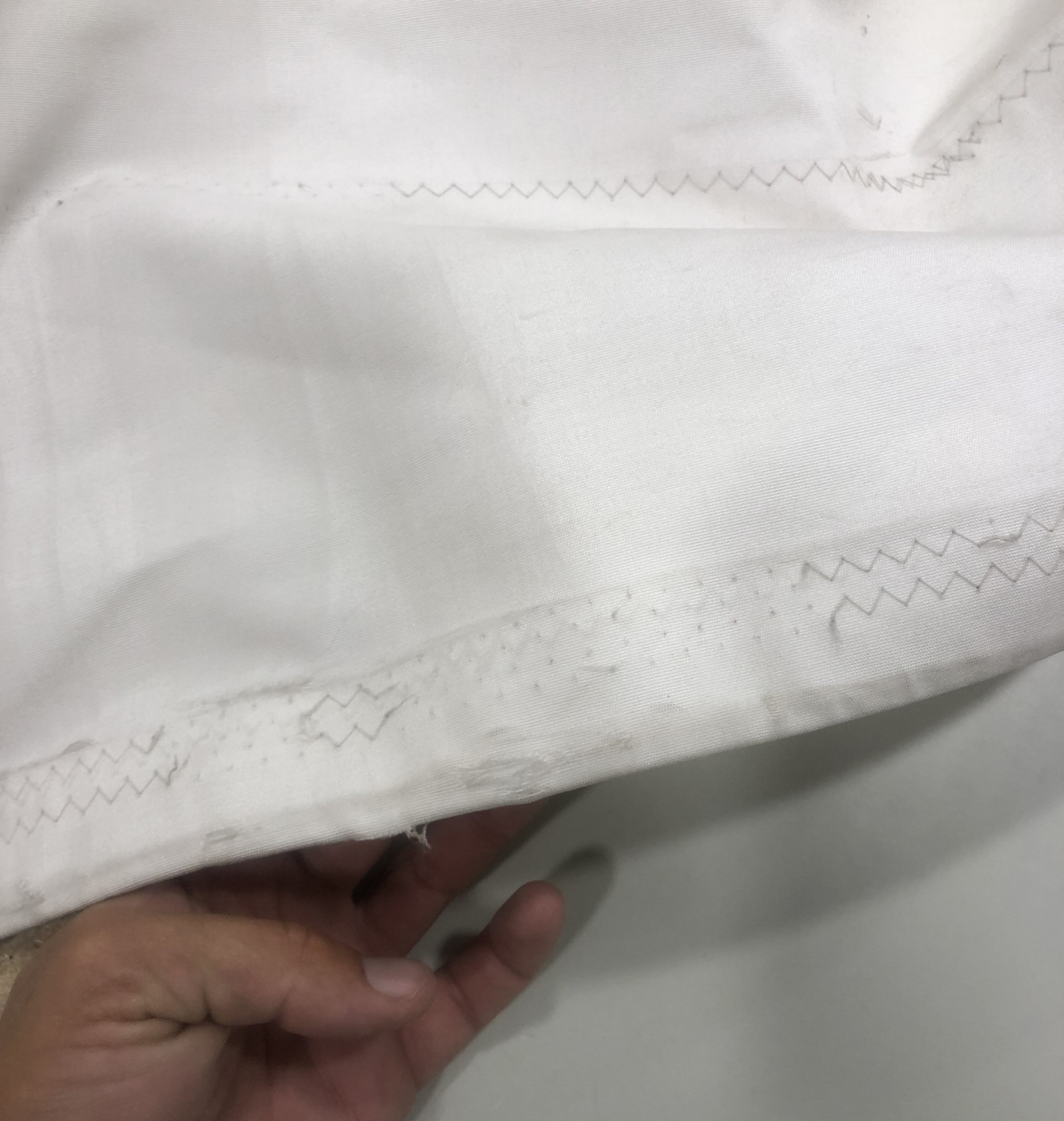 An example of chafe found in an inspection. A chafe patch will be applied to keep the sail from getting ripped in the future. If this small damage was not found, the sail could have kept getting damaged to the point of failure.