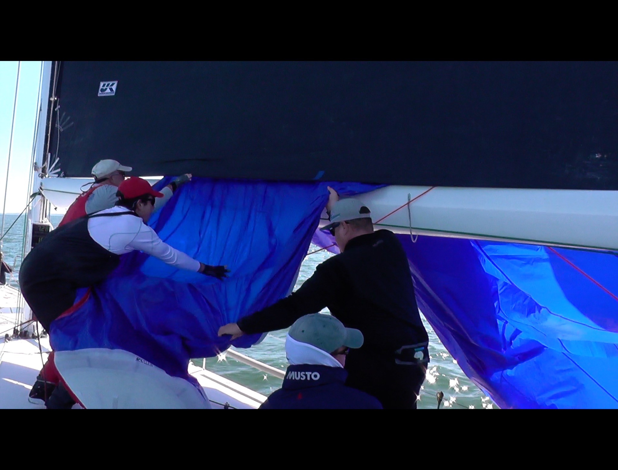 In the Letter Box take down, the spinnaker is pulled over the boom and under the foot of the mainsail before being stuff through the companion way hatch.