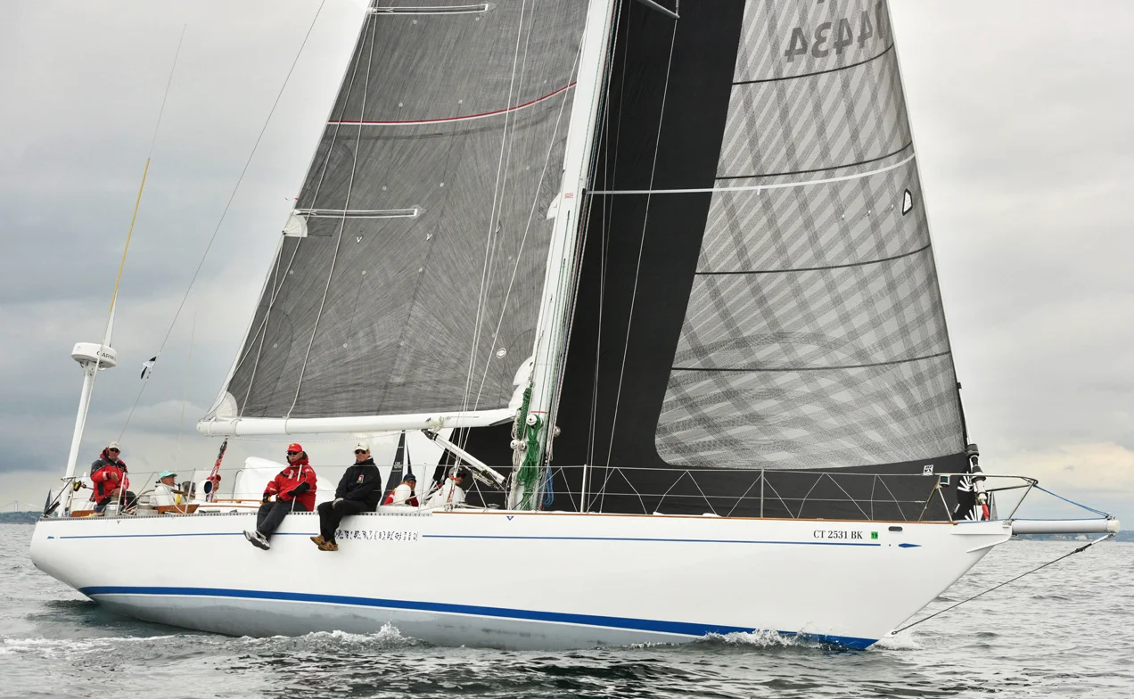 The S&S 49 HIRO MARU at the start of the 2018 Newport to Bermuda Race flying the same X-Drive No. 1 genoa she used in the Transatlantic race. Notice the partial black taffeta layer on the part the leech that overlaps the mast as well as on the part of foot that comes in contact with the life lines. Click on the picture to enlarge it and you’ll see Hiro driving while smoking his signature pipe.