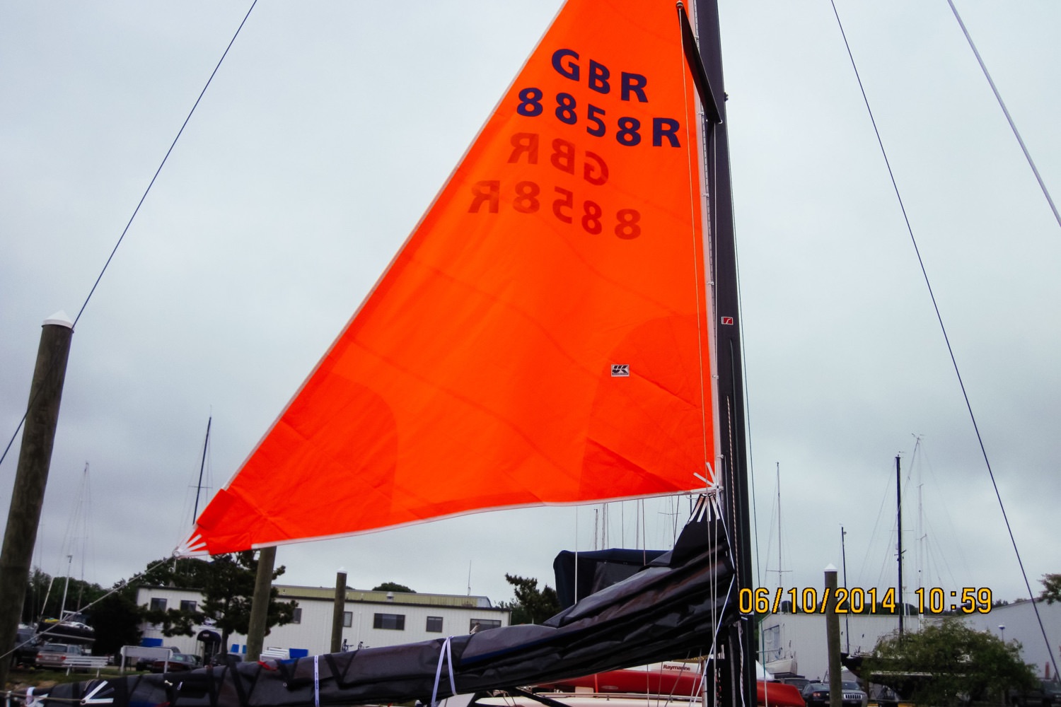 The "droopy clew" of the trysail allows the tack to be raised above the stack of mainsail luff cars when the sail is left on the boom.