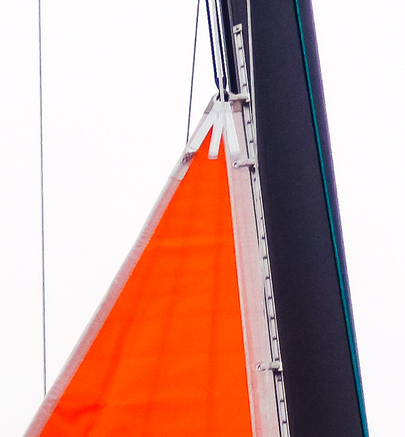 UK Sailmakers puts two slides at the head and tack of the storm trysail to spread the load at these highly loaded points. If the sail is inserted into a bolt rope track, we web on a 3-inch stainless steel slide at the head and tack.
