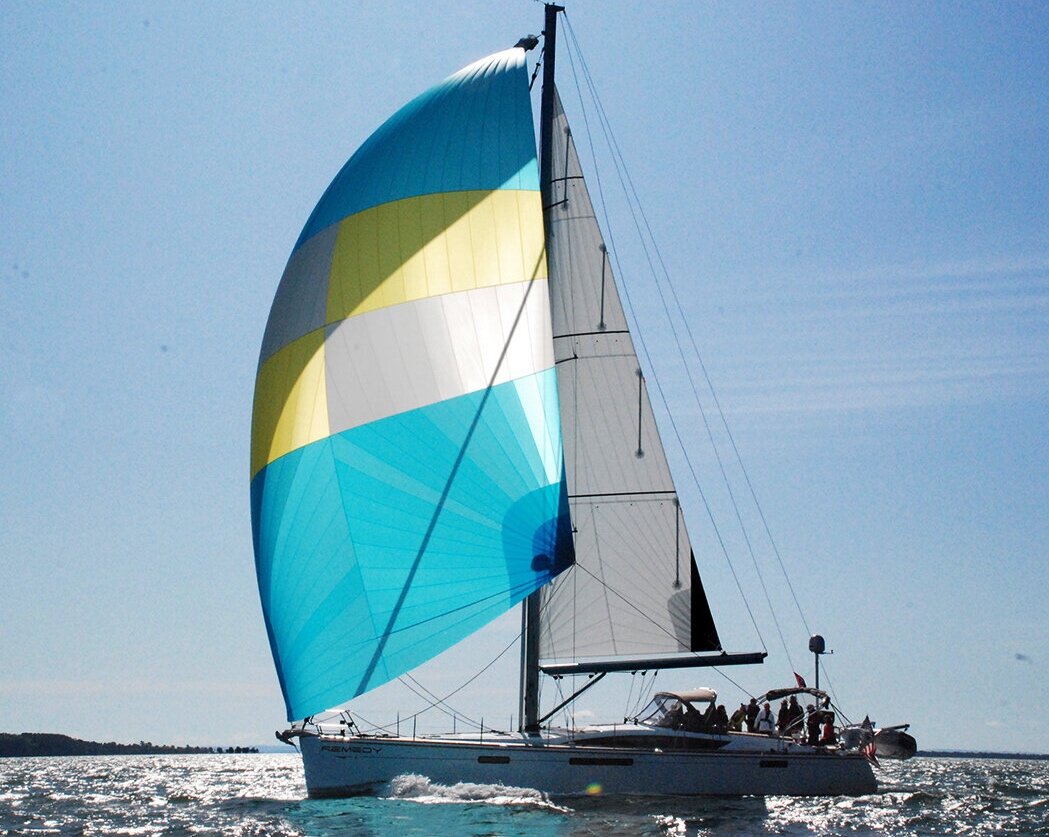 A Jeanneau 57 with a cruising gennaker and a Hydranet Radial roller furling mainsail that has vertical battens.