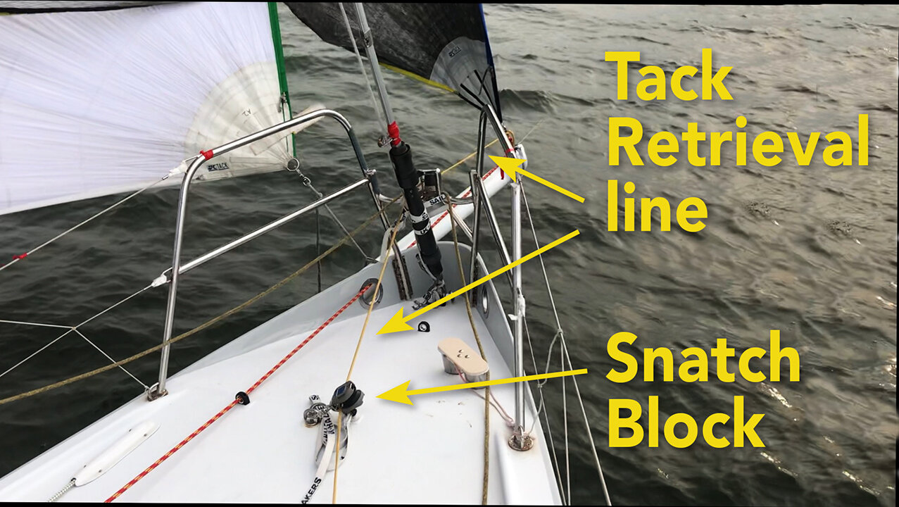 With this tack retrieval line set up, the crew member in the cockpit can winch the tack of the code zero from the end of the pole to the middle of the foredeck so that it can be gathered easier.