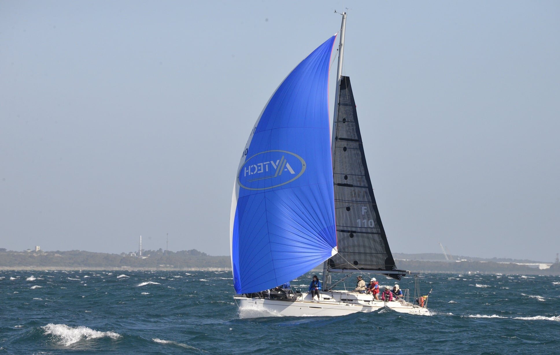 The Beneteau First 30 MINKIE sailing with her reefed X-Drive carbon main and small spinnaker while the Fremantle Doctor is in.