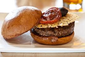 Umami Burger . Parmesan frisco, shiitake mushrooms, roasted tomato, caramelized onions, umami house ketchup.