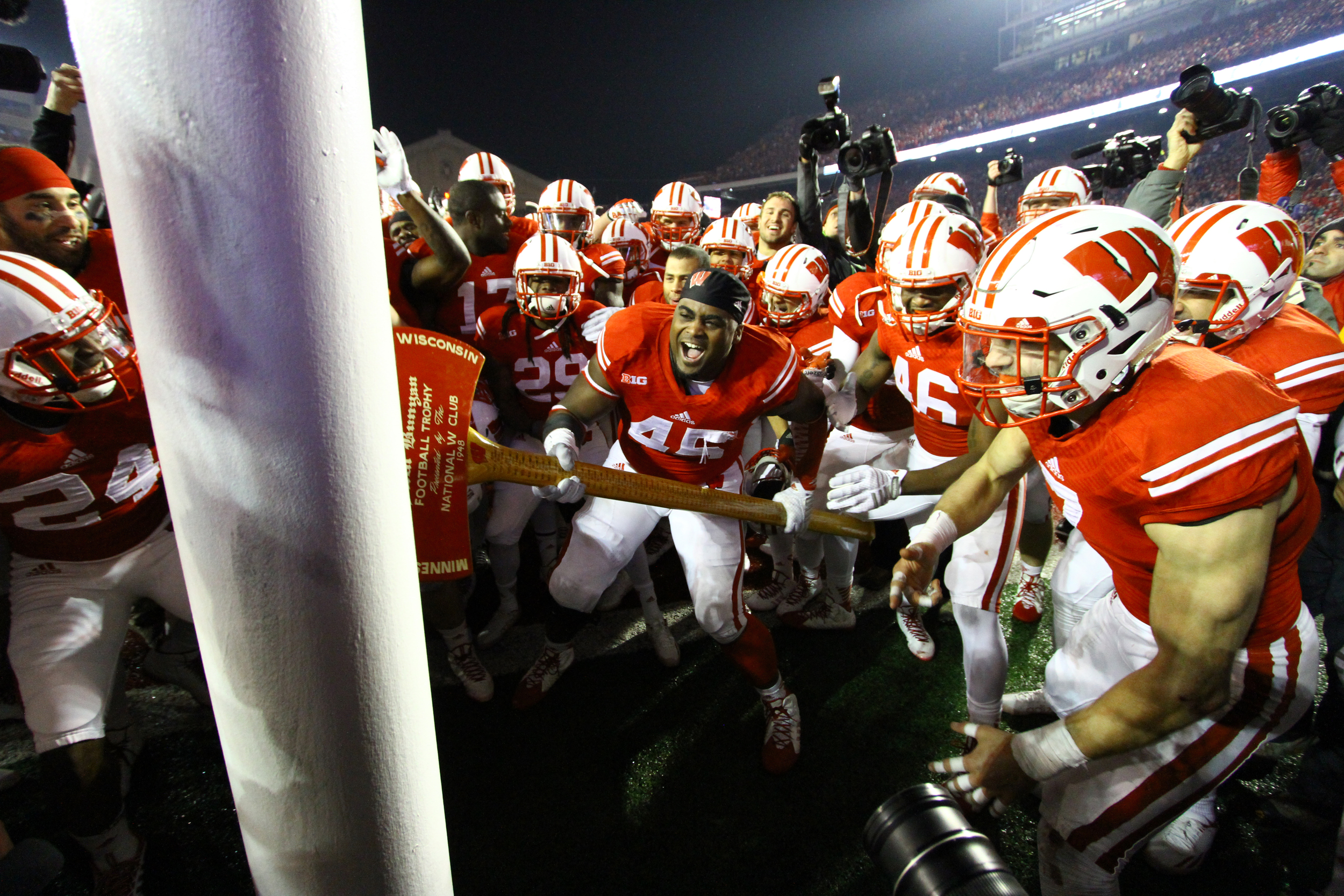 Warren Herring chops down the goal post with Paul Bunyan’s Axe. Following a victory over Minnesota every senior gets to chop with the six-foot tall axe. 