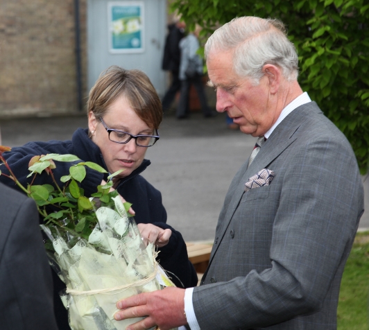 Lucy Simpson, manager at Poundbury Gardens, presents HRH The Prince of Wales with an old fashioned yellow shrub rose, named Charlotte.&nbsp;Picture courtesy of Neil Crick ARPS.
