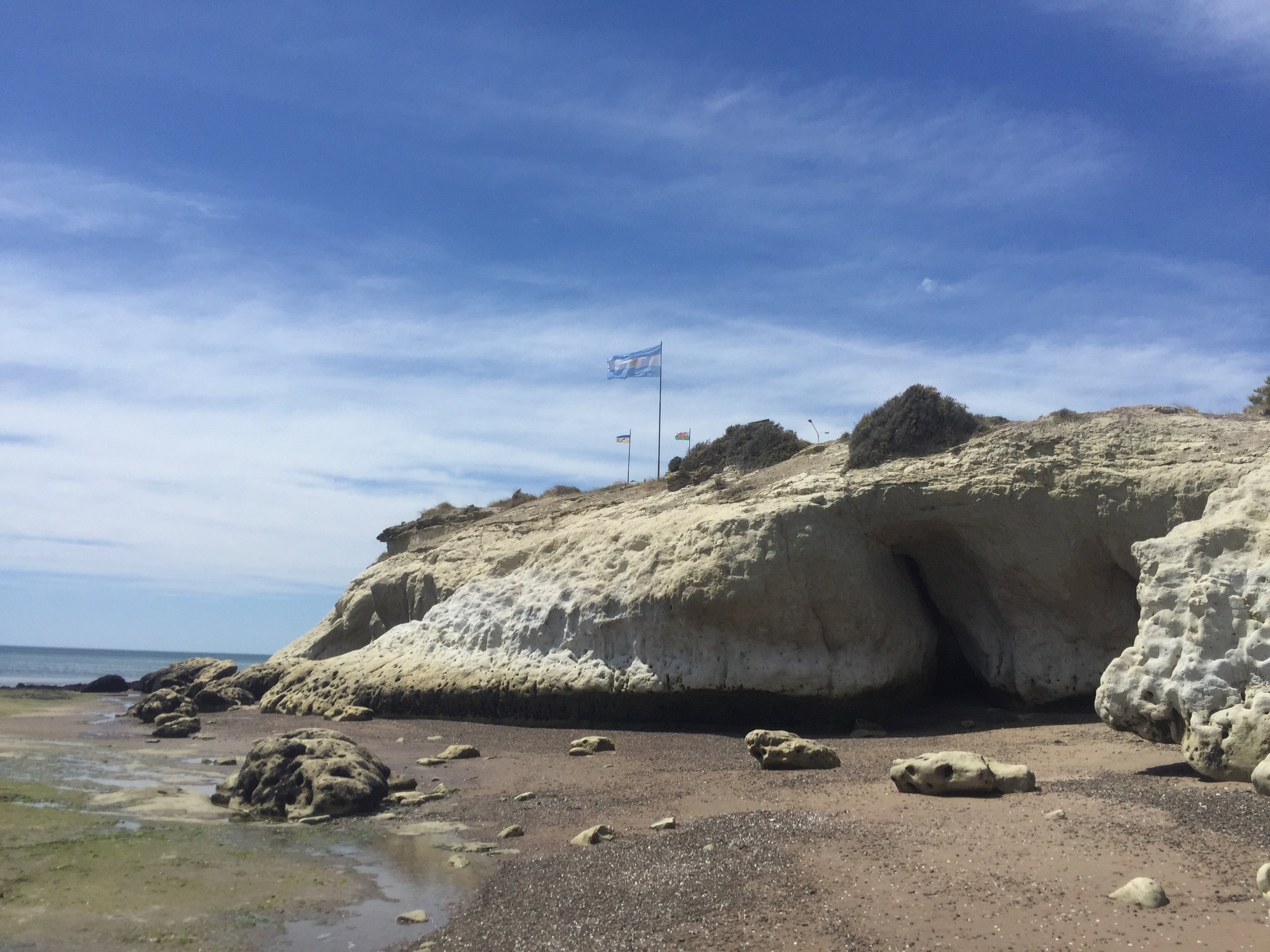 Flags to mark where the settlers landed at what is now Puerto Madryn; they lived in those caves for a bit.
