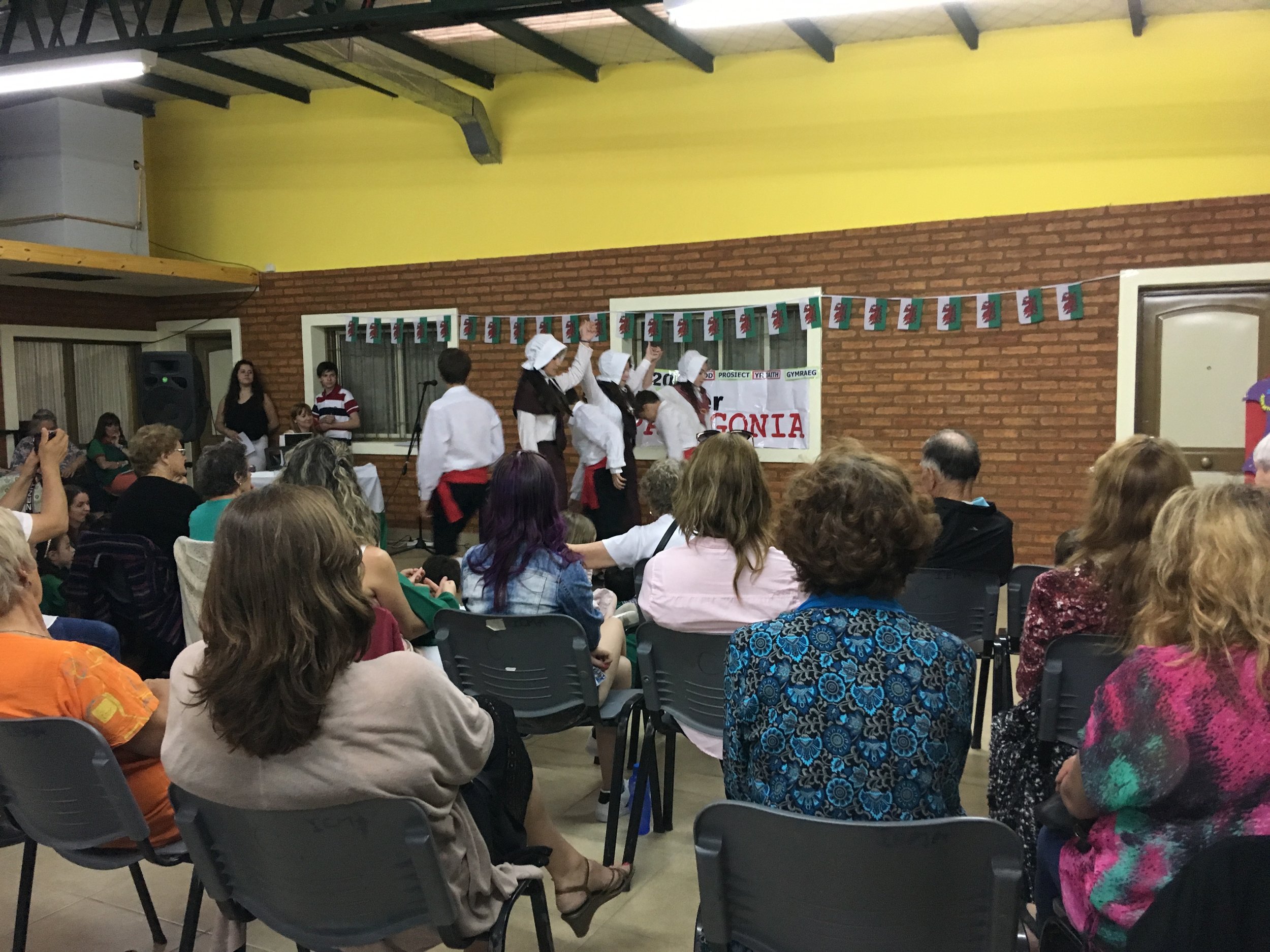  At the concert in Gaiman: local kids do a complicated dance, with the added complication of bonnets. 