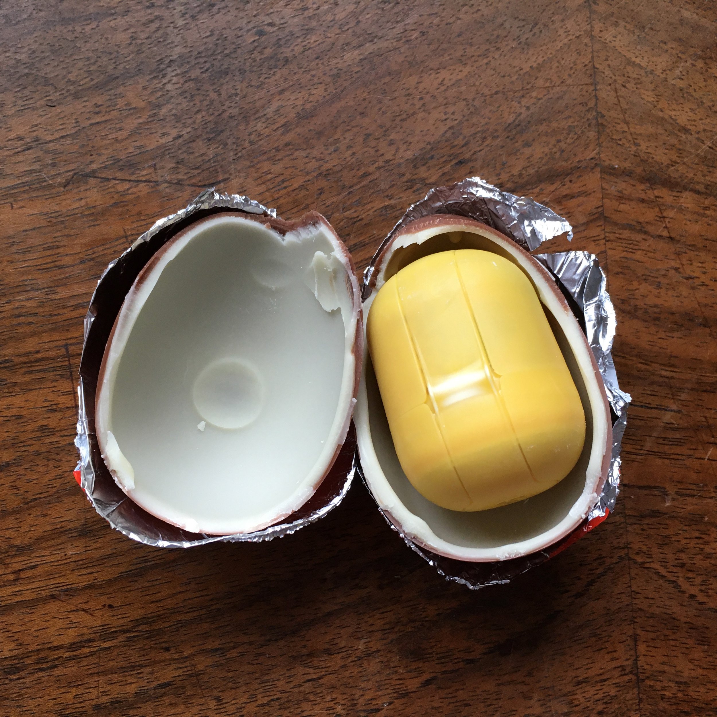  the chocolate egg opened up to reveal the yellow plastic capsule, AKA the yolk 