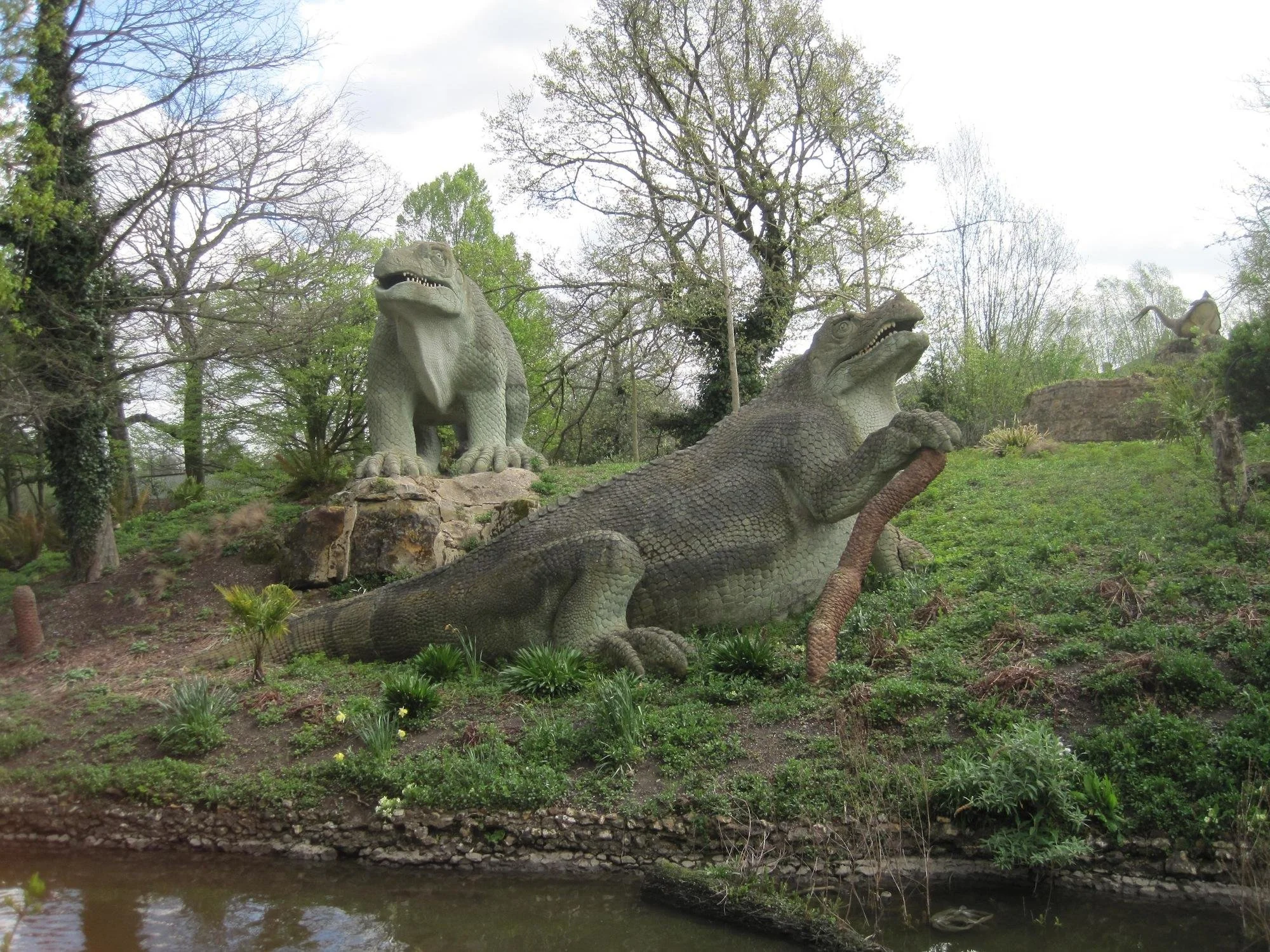  Two iguanodon sculptures, one posing with its front foot on a stick, the other has had a refurb so it is a much brighter green, and its toenails are dazzling white, like tooth veneers but for feet.  